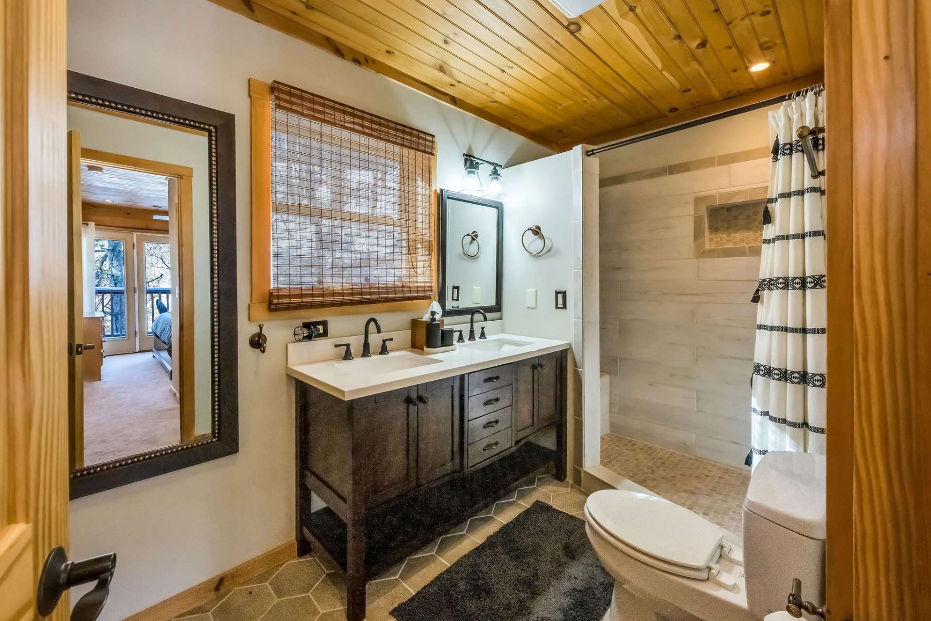 The newly renovated upper-level full bath features a Jack-and-Jill design, providing seamless convenience and accessibility to both bedrooms.