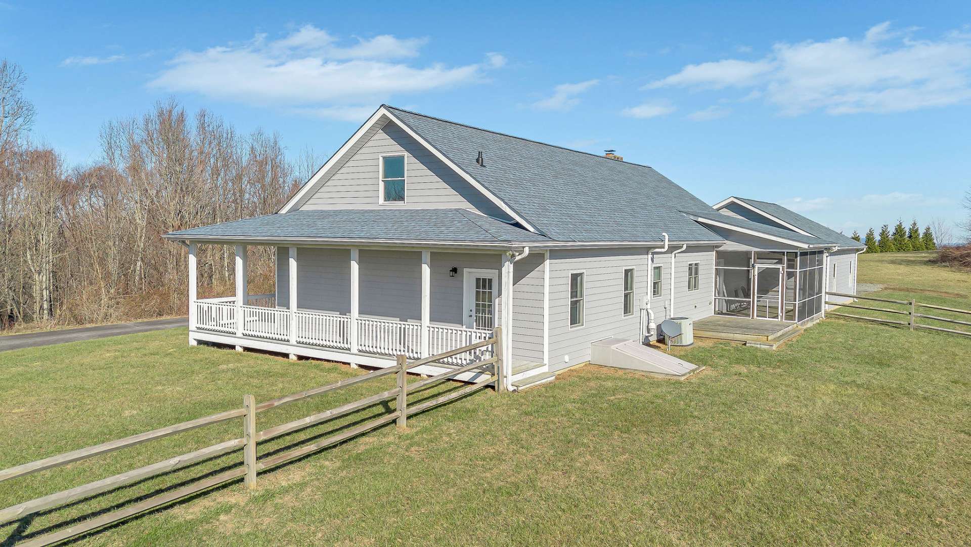 A wraparound porch and a screened-in porch off the kitchen provide peaceful spaces to relax and take in the stunning scenery.