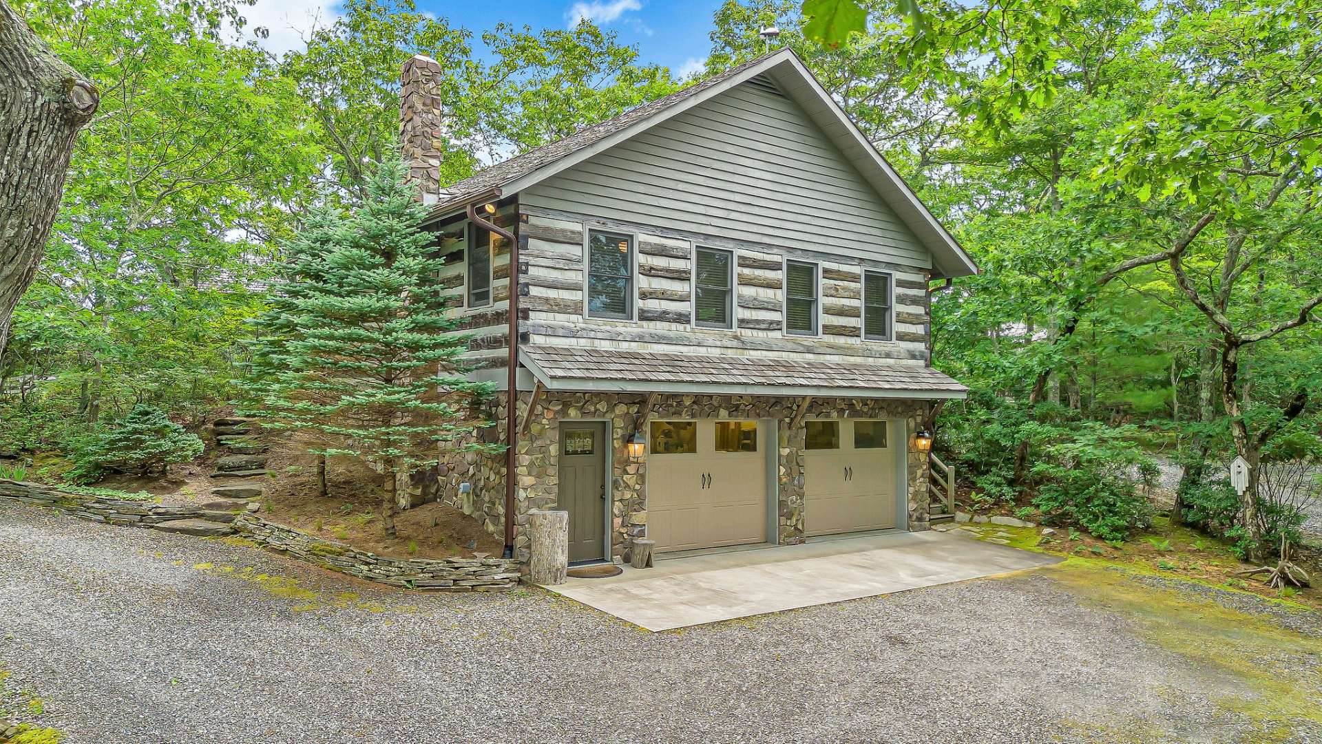 Circular driveway leads down to the lower level 2-car garage with easy access to main cabin.