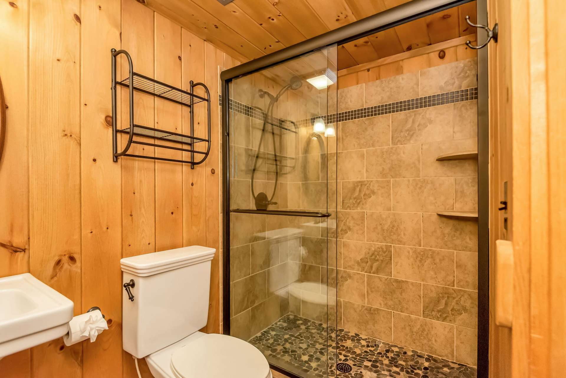 The lower level bath has another beautiful tiled shower.