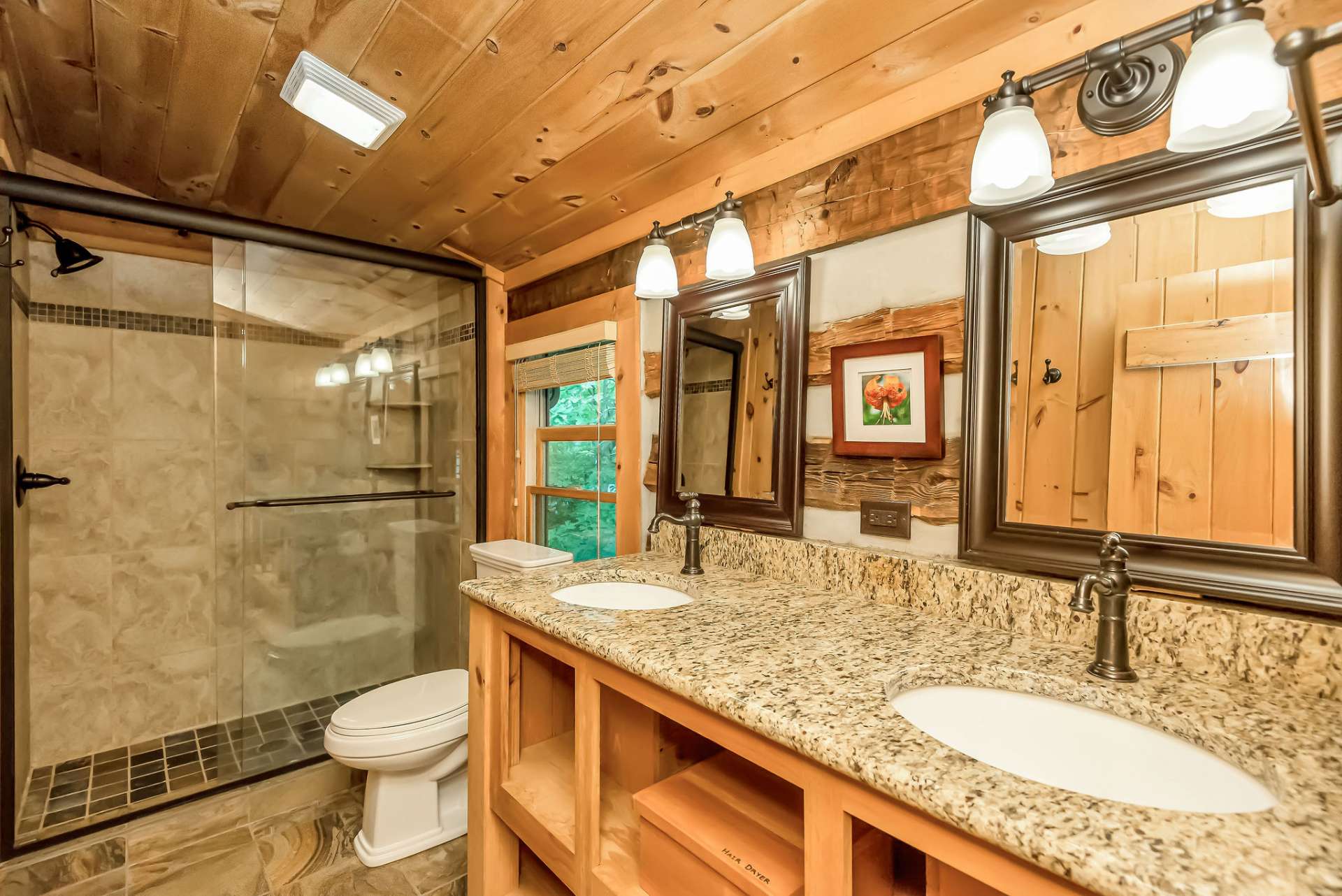 The upper-level bath creates an atmosphere of comfort with double sinks and a tiled shower.