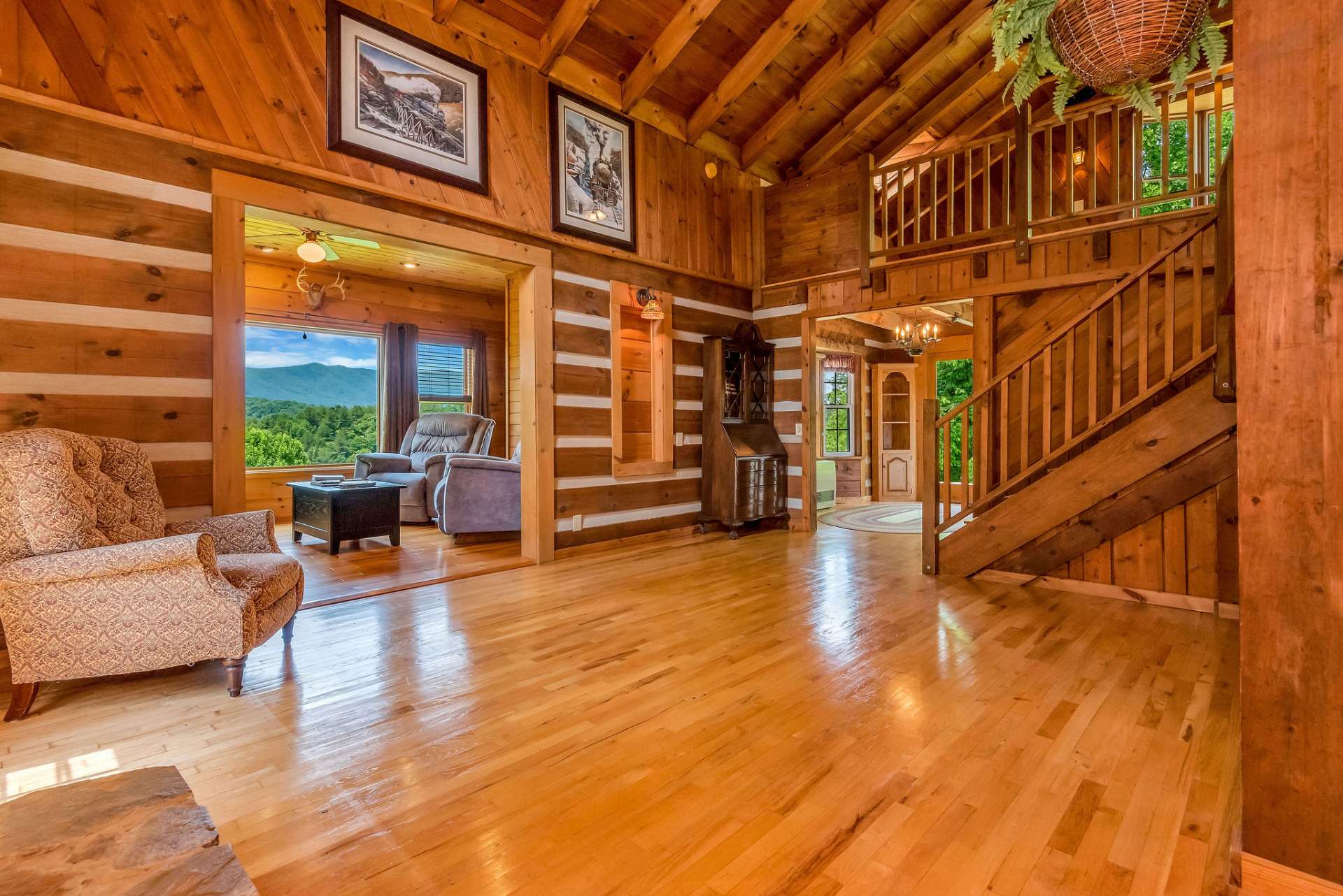 The living room offers access to a small den, an open stairway leading to the loft, dining/kitchen area and primary bedroom/bath.