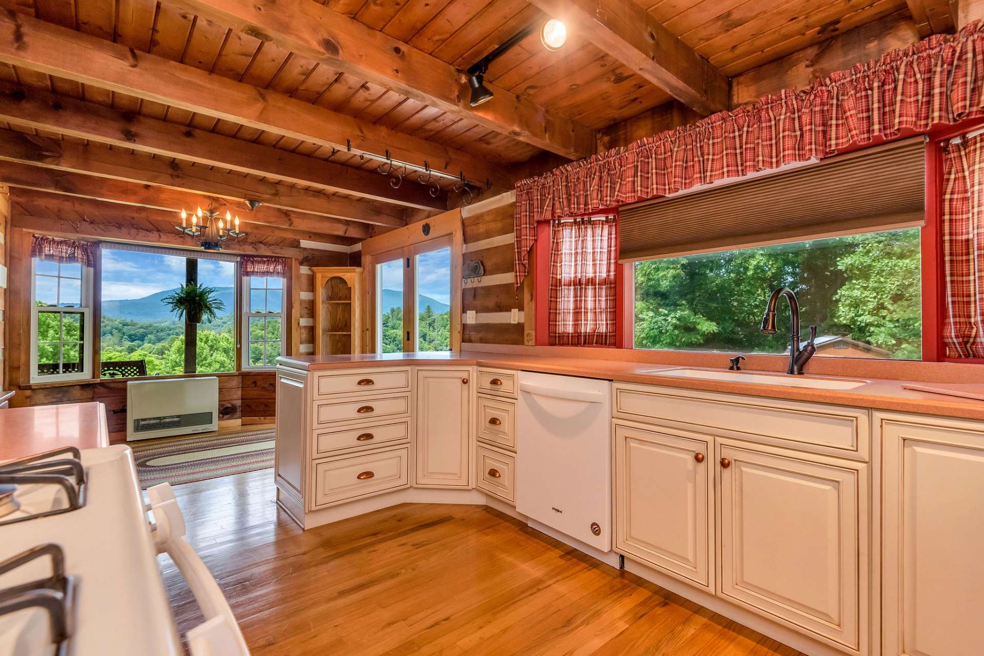 The kitchen offers ample cabinet and countertop space, complemented by a bay window that fills the room with natural light, creating a bright and spacious atmosphere.