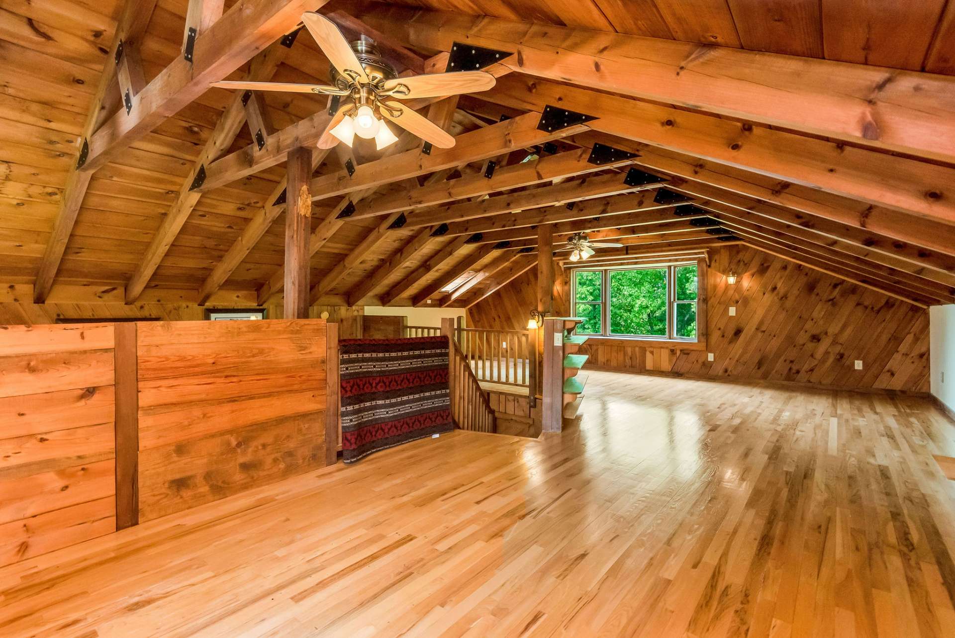 The expansive open loft area creates a sense of spaciousness and connection within the cabin.