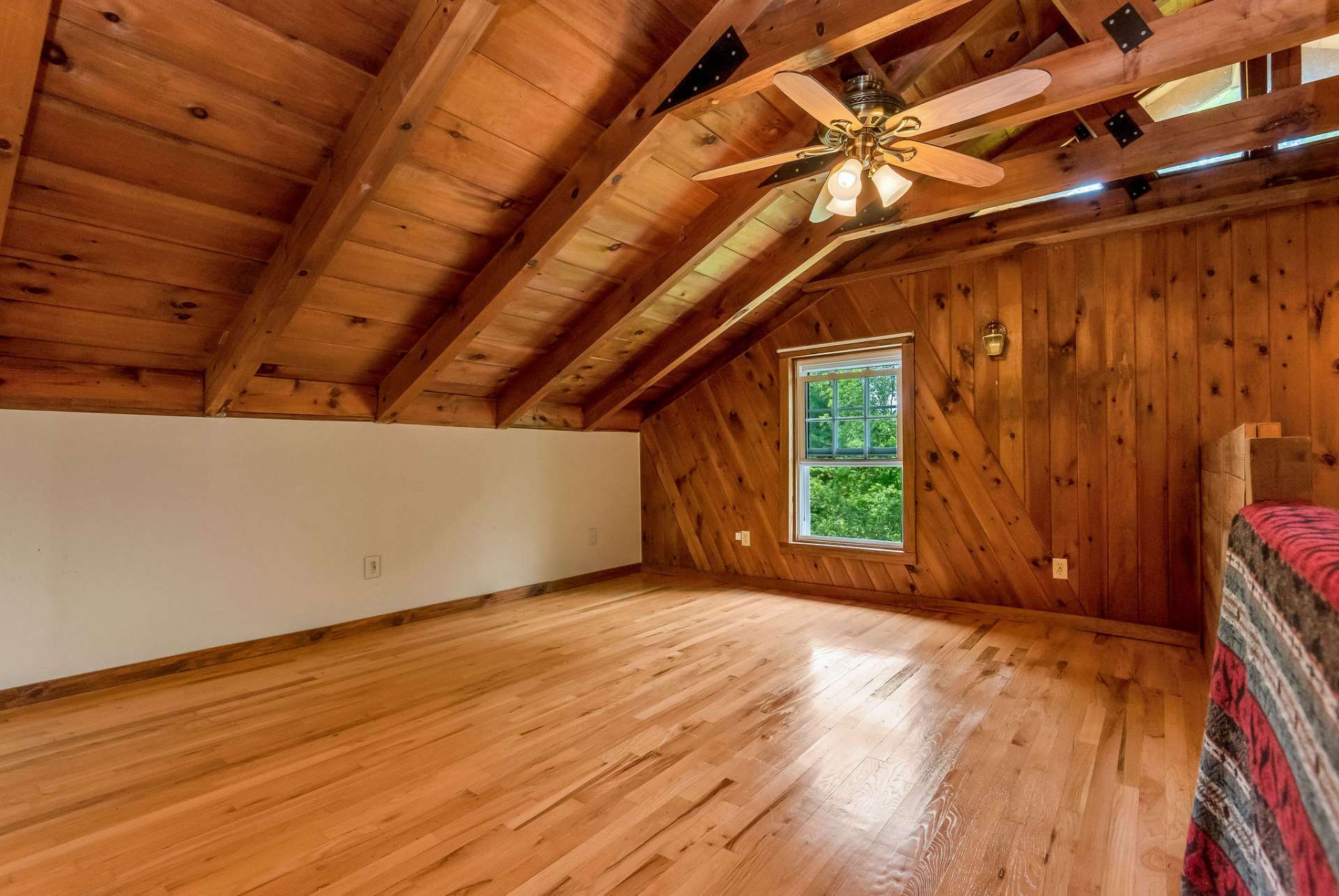 Highlighted by its vaulted ceiling and exposed beams, the loft exudes rustic charm and architectural character.