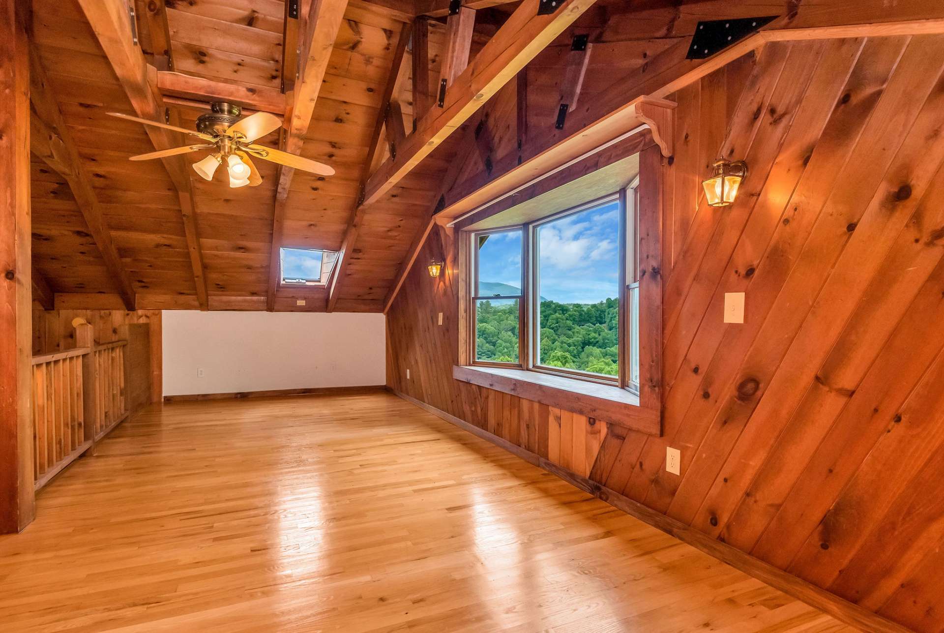 Whether used for overnight guests, personal workspace, or simply enjoying the panoramic views, the loft area adds depth and functionality to the cabin's layout, enhancing its appeal as a cozy retreat in the mountains.