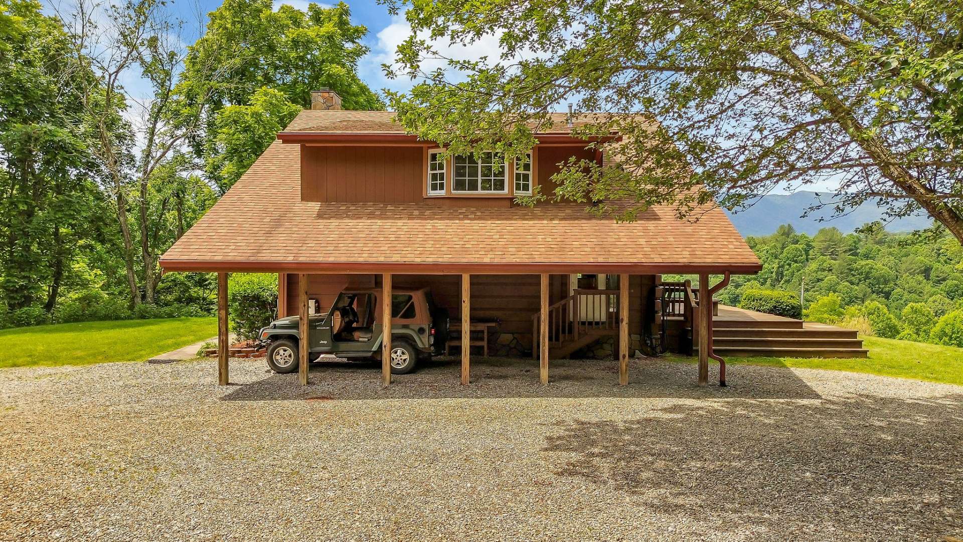 The driveway side features a 1-car carport and convenient access to the kitchen door, making it easy to carry in groceries.