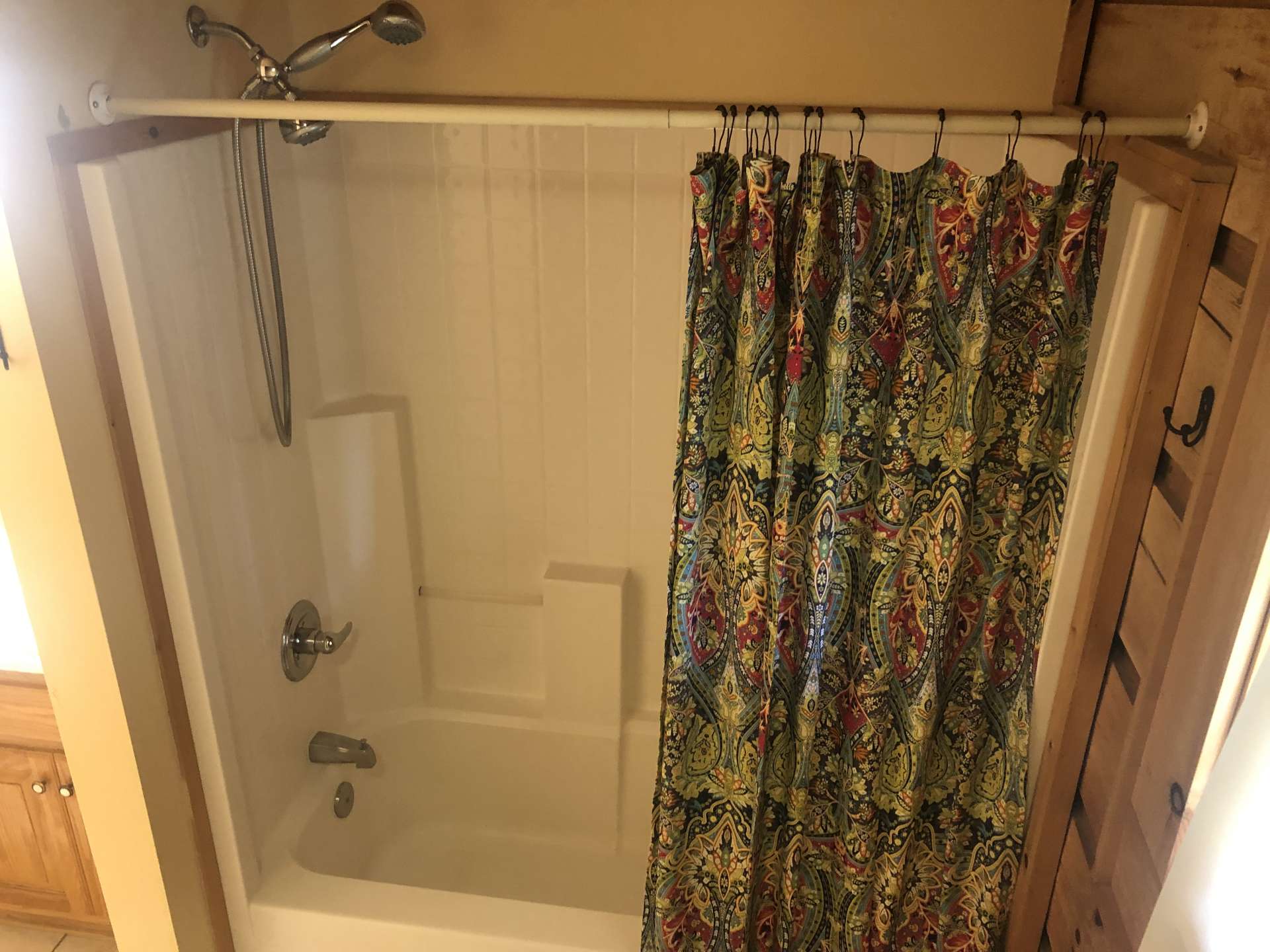 Main level bath has a tub/shower unit for guests