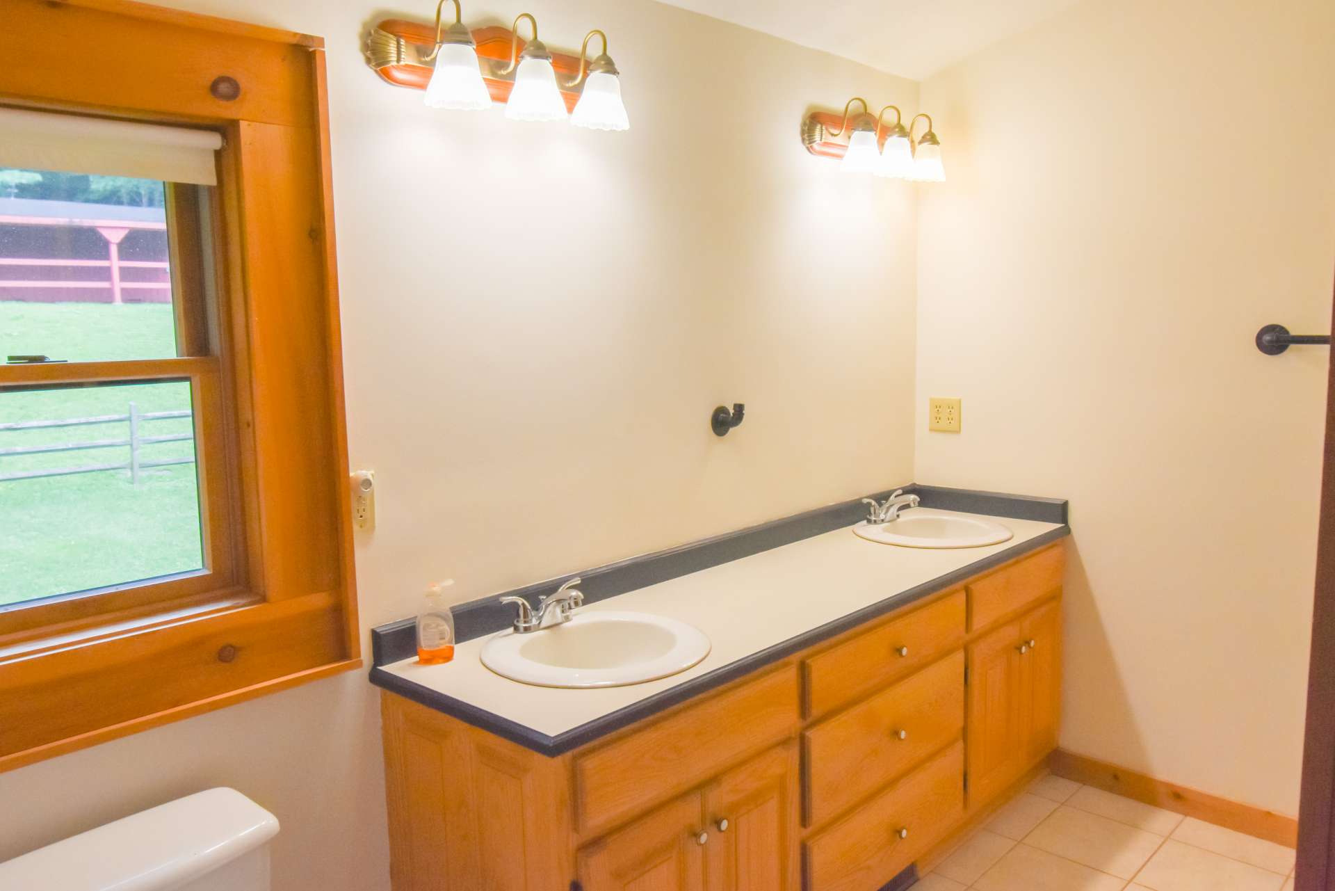 Primary Bath upstairs has double sinks with a large vanity for storage