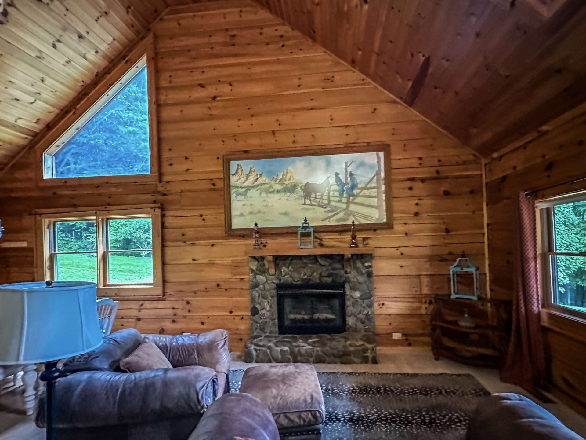 Vaulted ceiling great room with rock fireplace