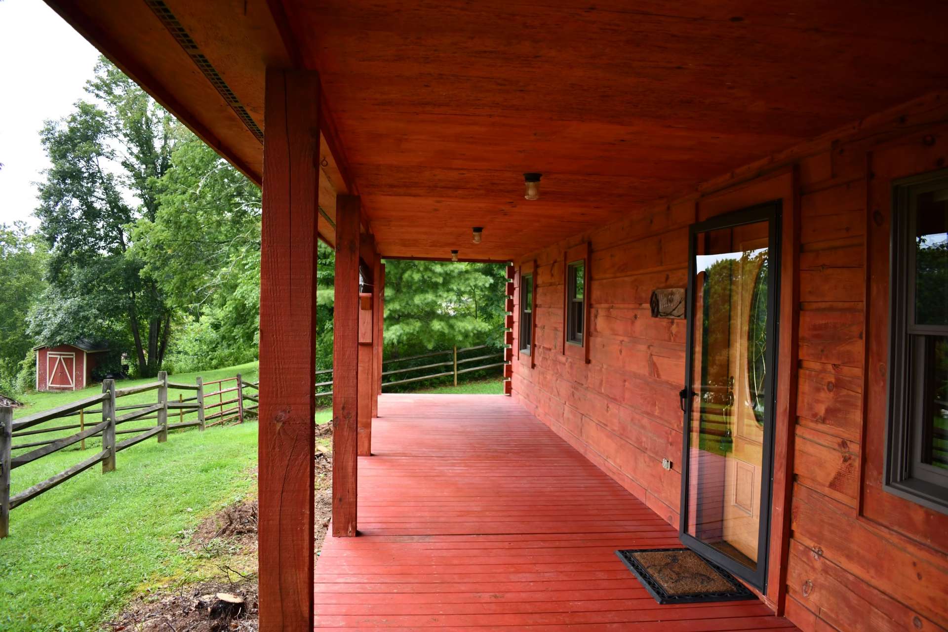 Rocking chair front porch with a peak at the New River below