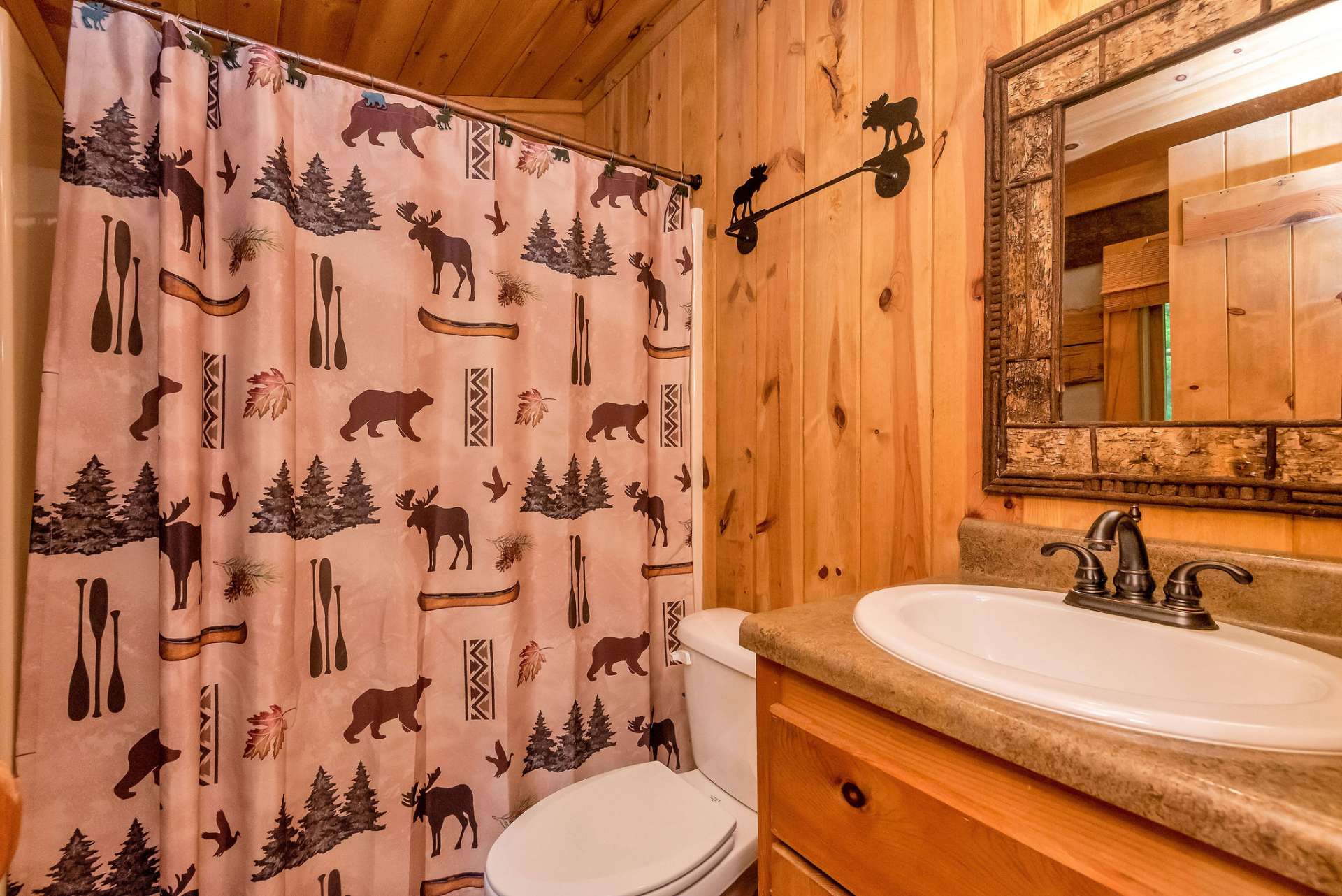 The main level bath is located between the great room and primary suite adding a layer of convenience uncommon in Stonebridge Cabins.