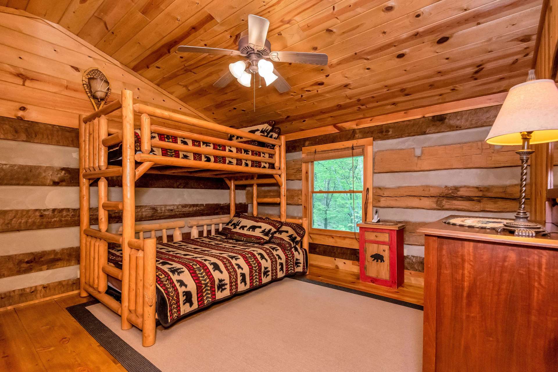 The vaulted wood ceiling and creek-side window make this guest room truly exceptional.