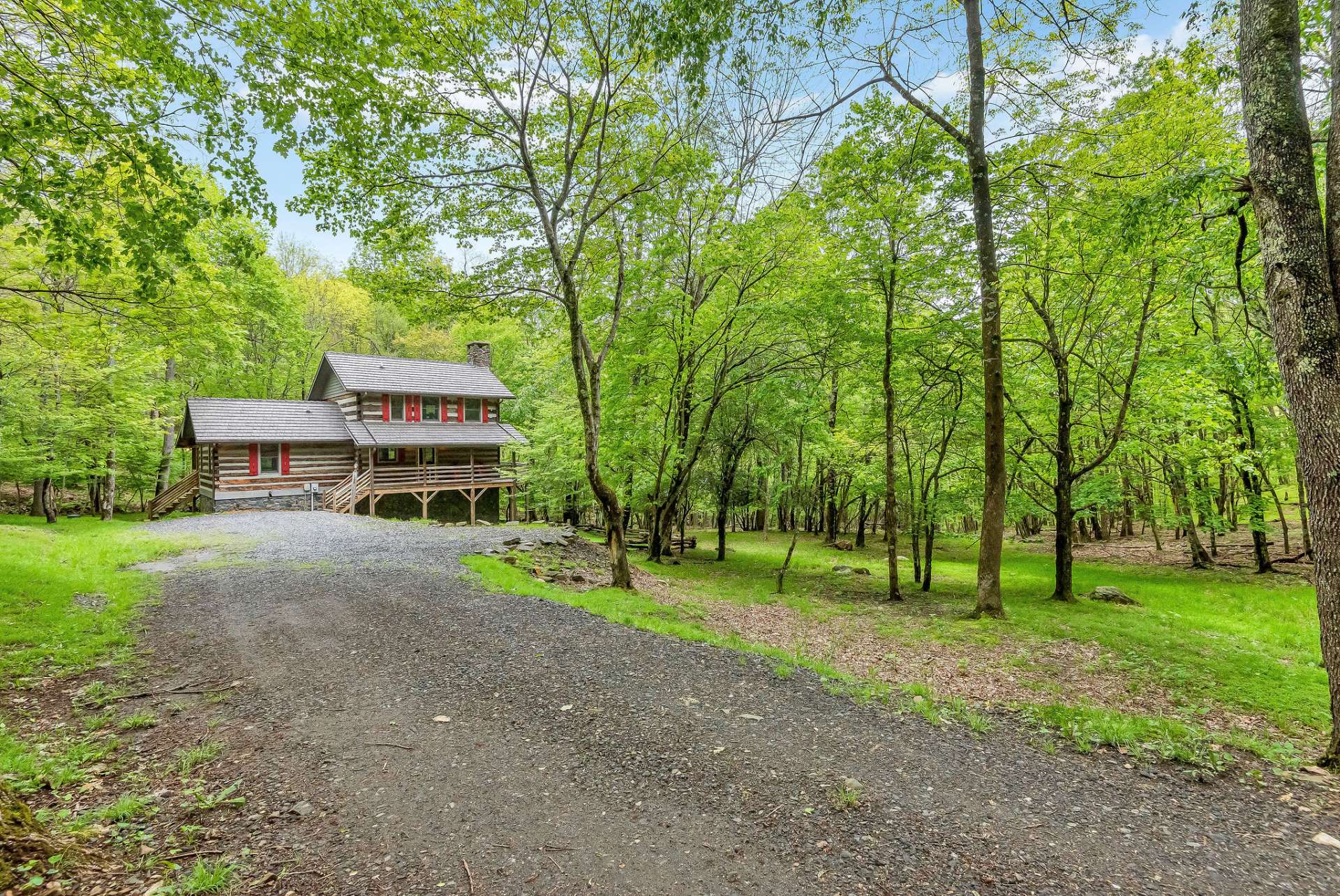 A private driveway leads down to this picturesque setting offering residents and visitors a unique opportunity to experience the serenity of forested landscapes and the warmth of traditional log home living.