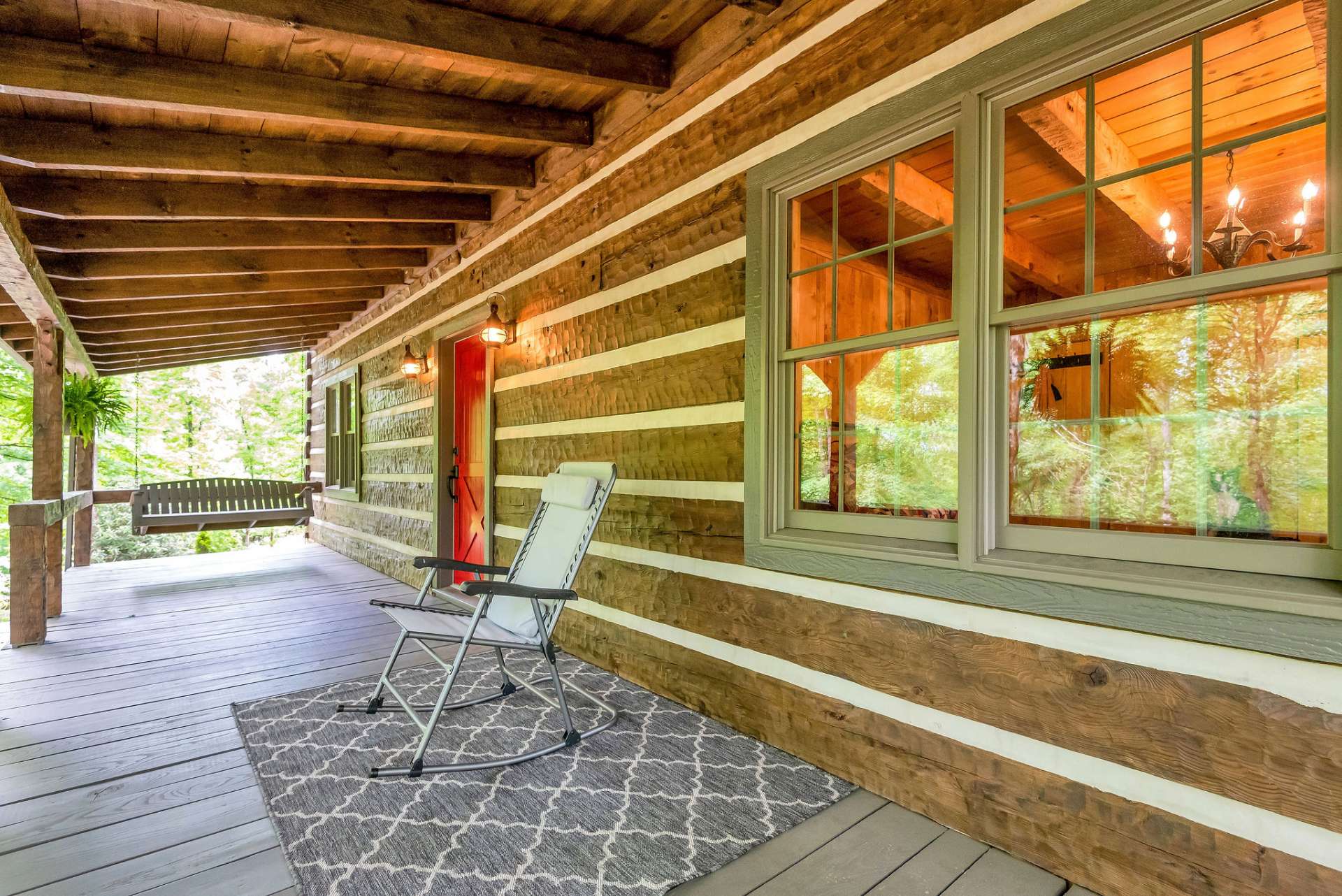 No cabin is complete without a covered front porch with a swing and rocking chairs.