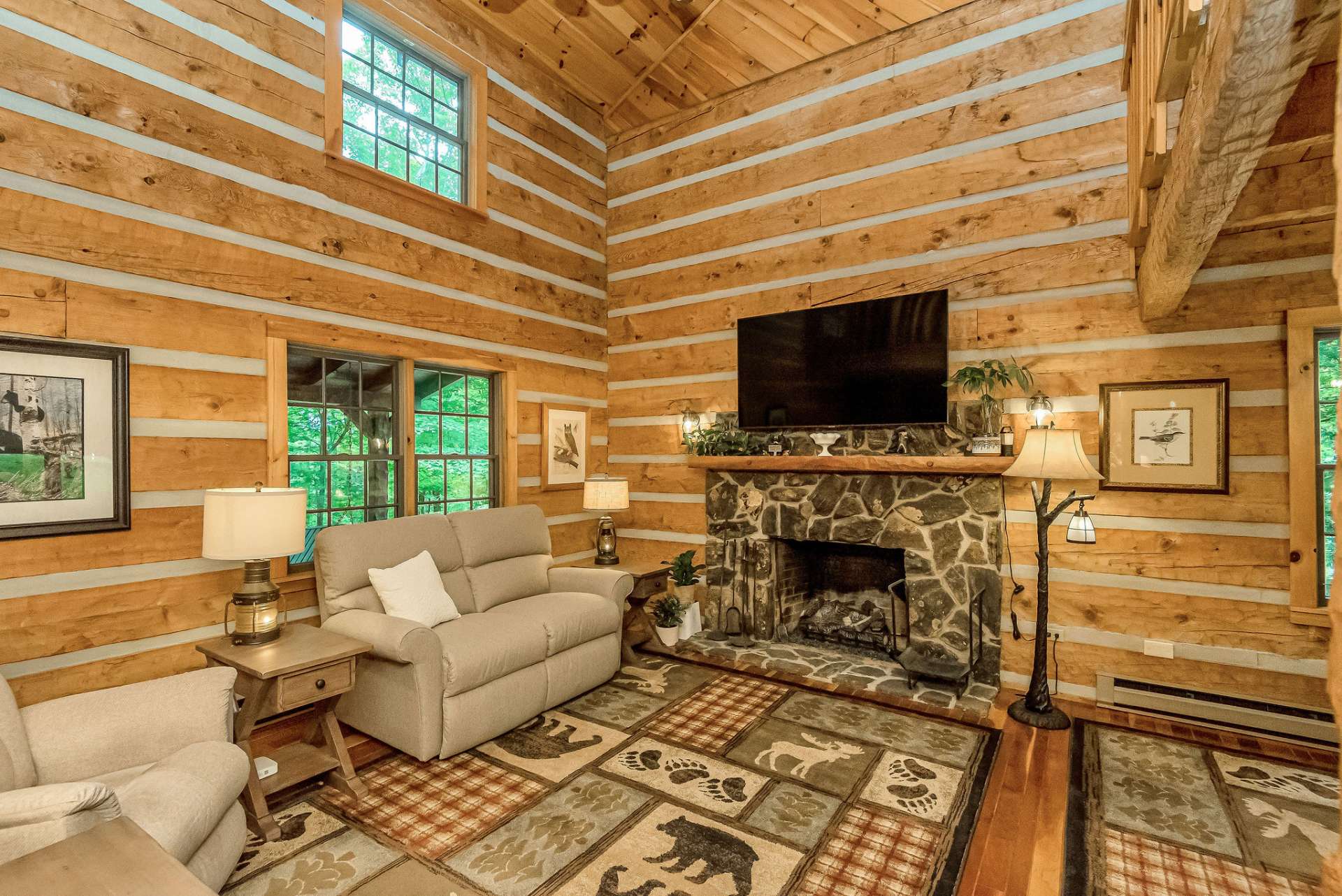 While the native stone fireplace currently offers gas logs, the option for conversion to wood-burning adds to the rustic allure. (Currently, no propane tank on site.)