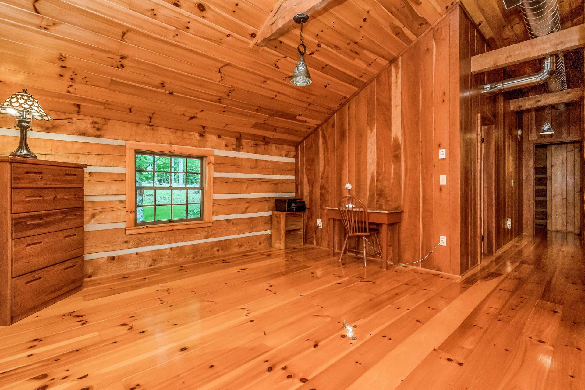 With its vaulted ceiling and several windows filling the space with natural light, the loft feels airy and inviting, perfect for relaxing or getting work done in a tranquil setting.