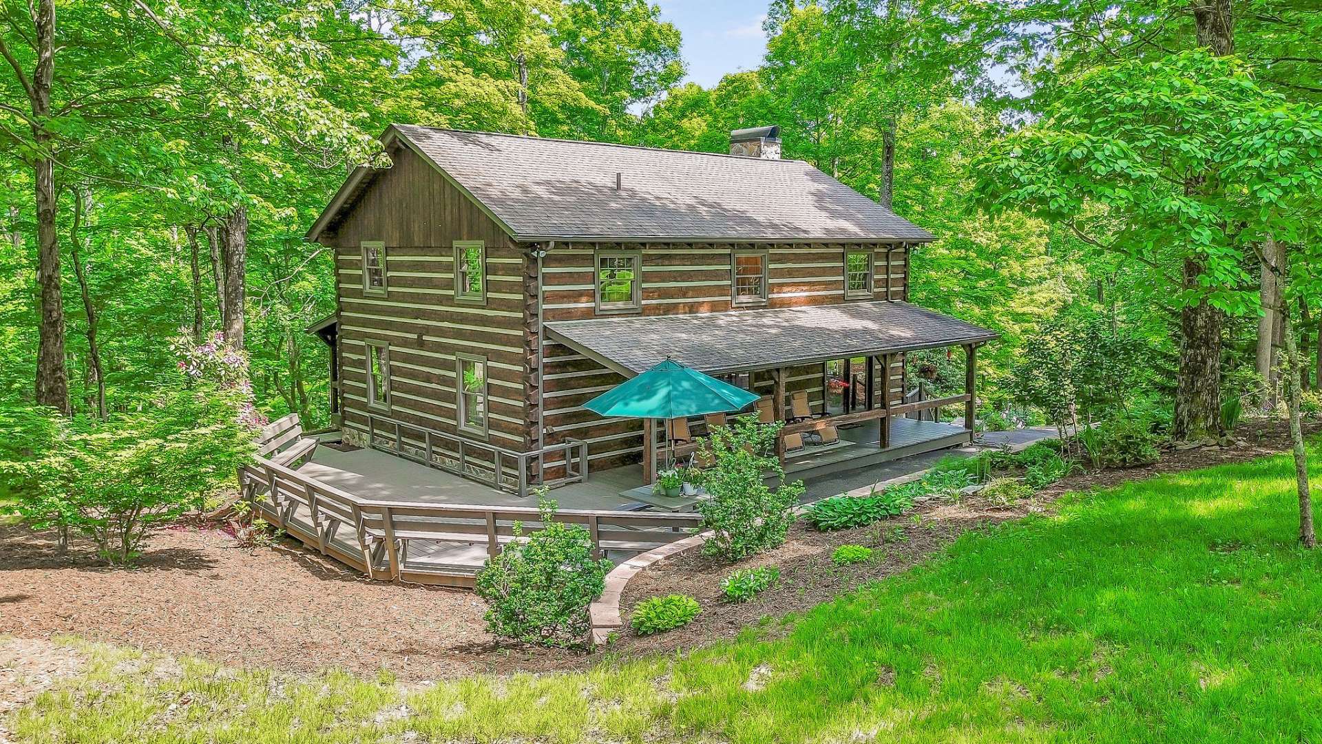 The cabin features a covered back porch and an expanded open deck, perfect for enjoying the natural surroundings.