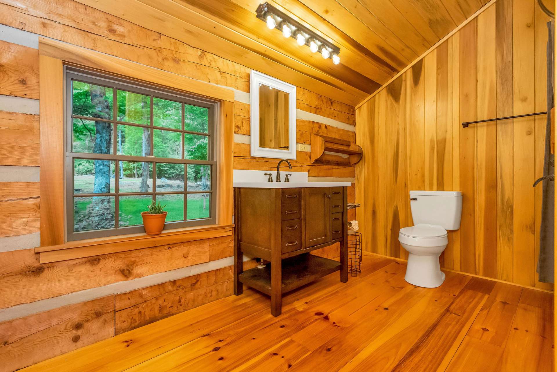 The spacious upper-level bathroom includes a new rustic yet elegant vanity and a fiberglass tub/shower combination.