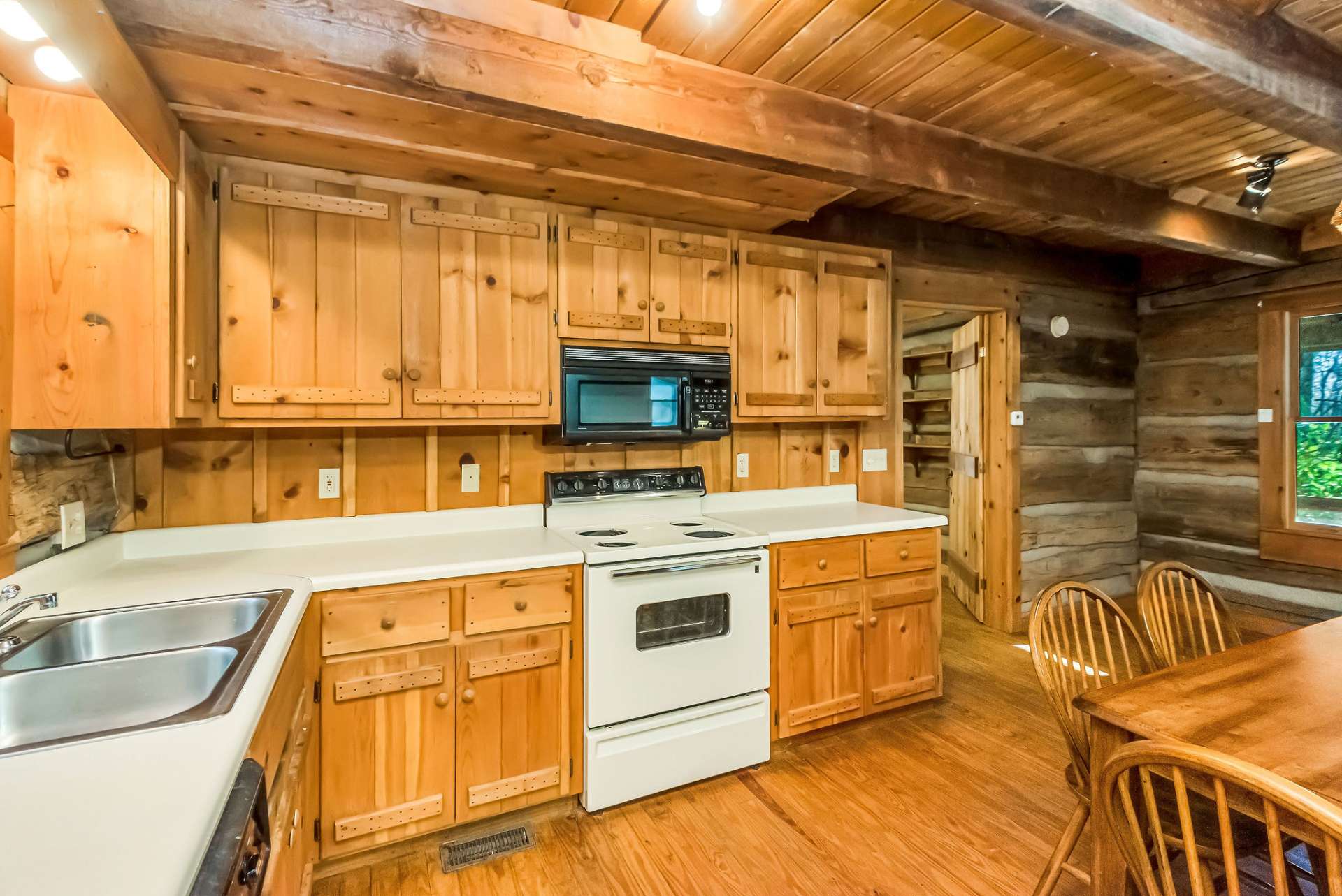 Savor the craftsmanship of custom cabinets, designed to provide plenty of storage and elevate the kitchen’s rustic charm.