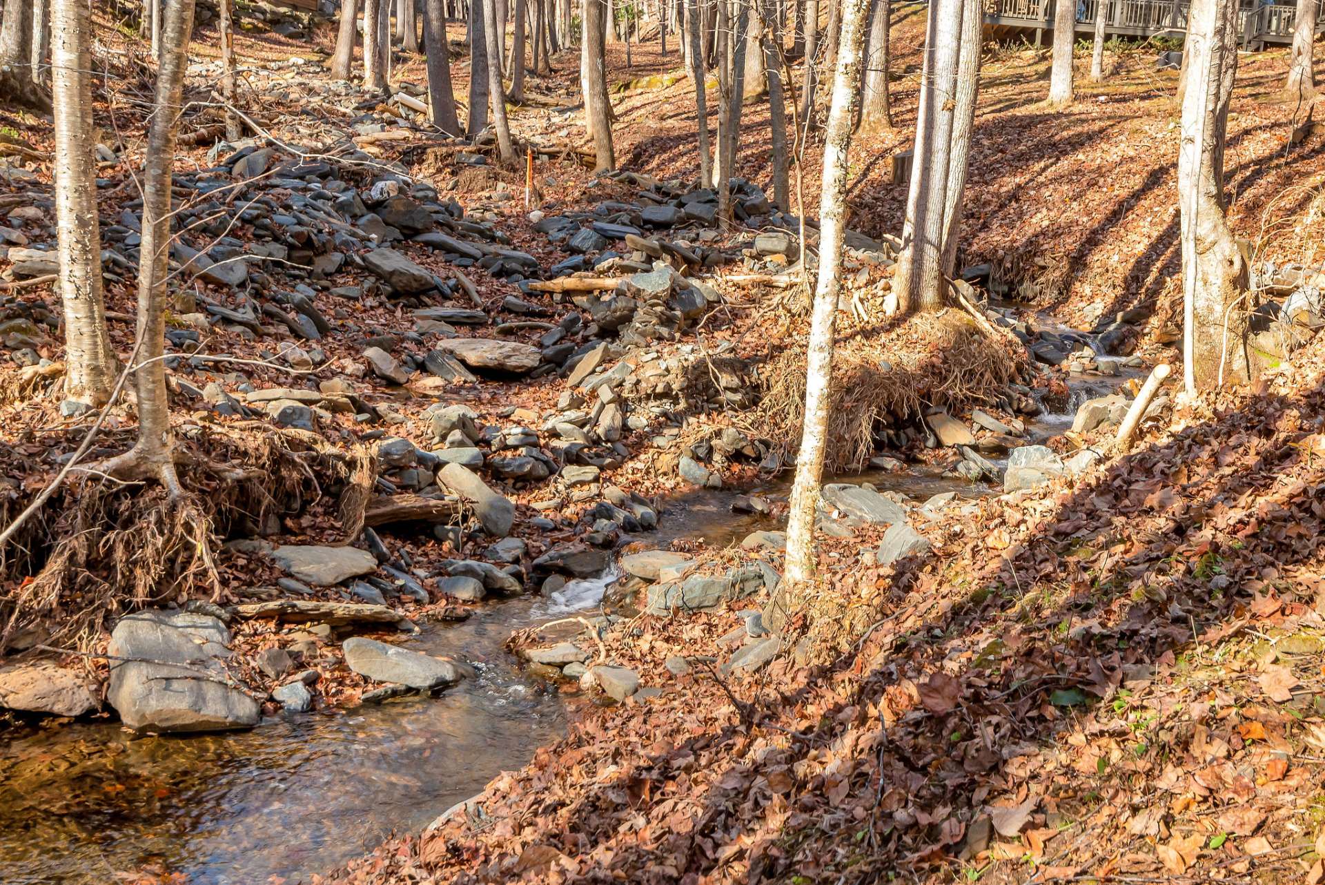 Beside the cabin a mountain stream tumbles over multiple waterfalls, filling the air with the calming sounds of cascading water—nature's lullabies to soothe your spirit.