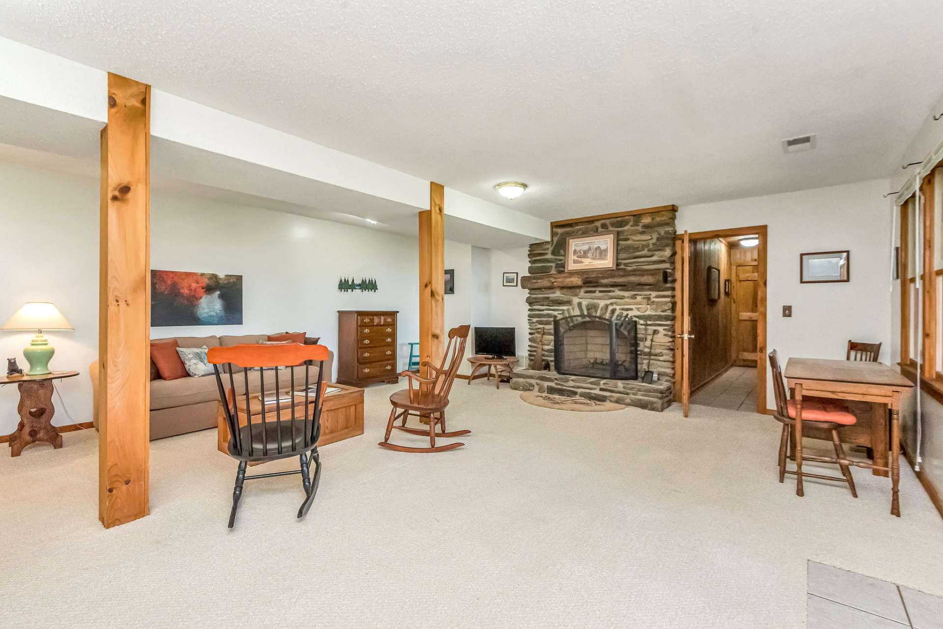 The family room welcomes you with a second stone fireplace.