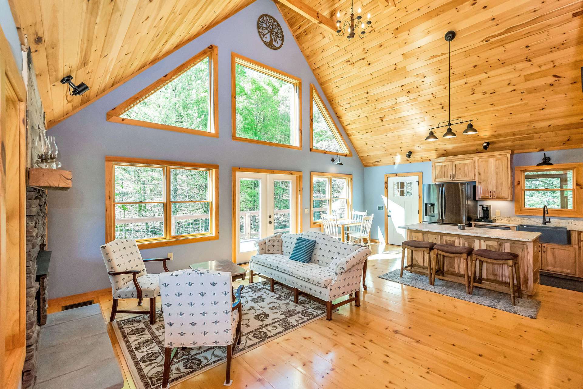 Barn wood accents above the fireplace add mountain charm and complement the stone.