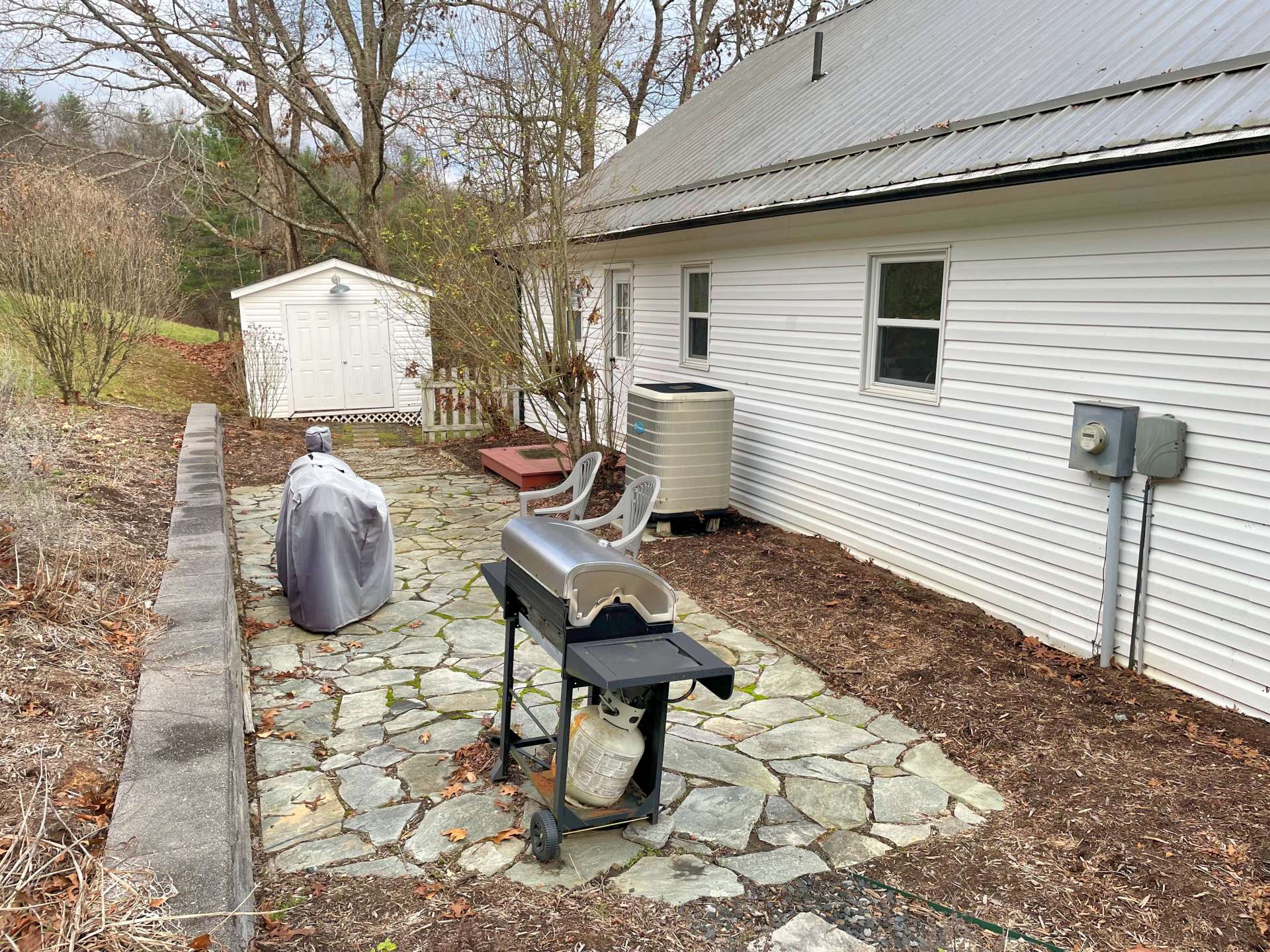 Back stone patio for outdoor grilling and entertaining