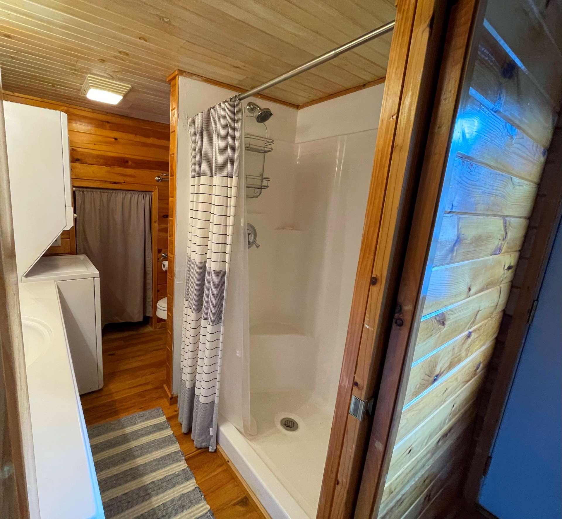 The primary bath offers a walk- in shower enclosure and laundry area.