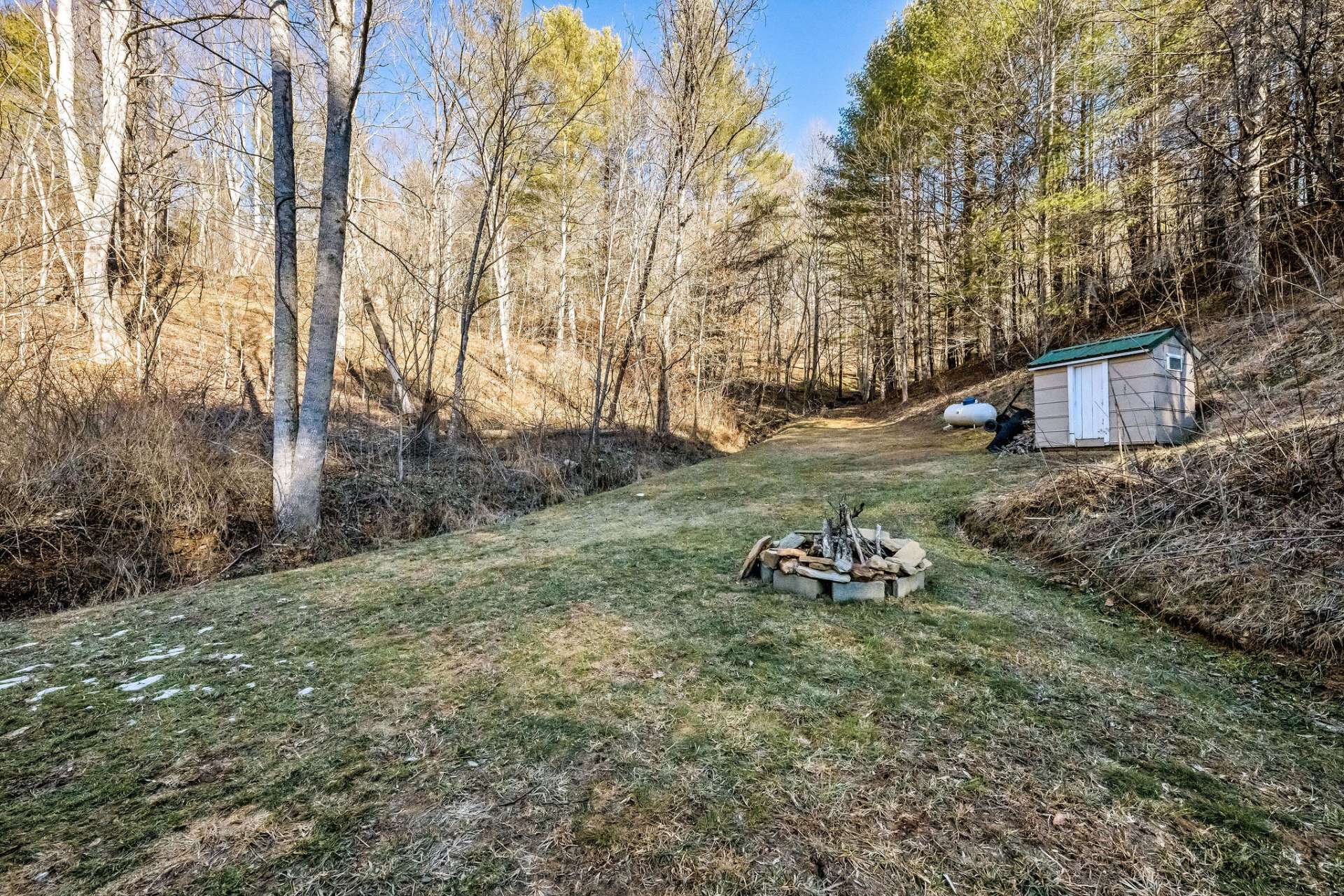 A small storage shed behind the house creates extra storage space.