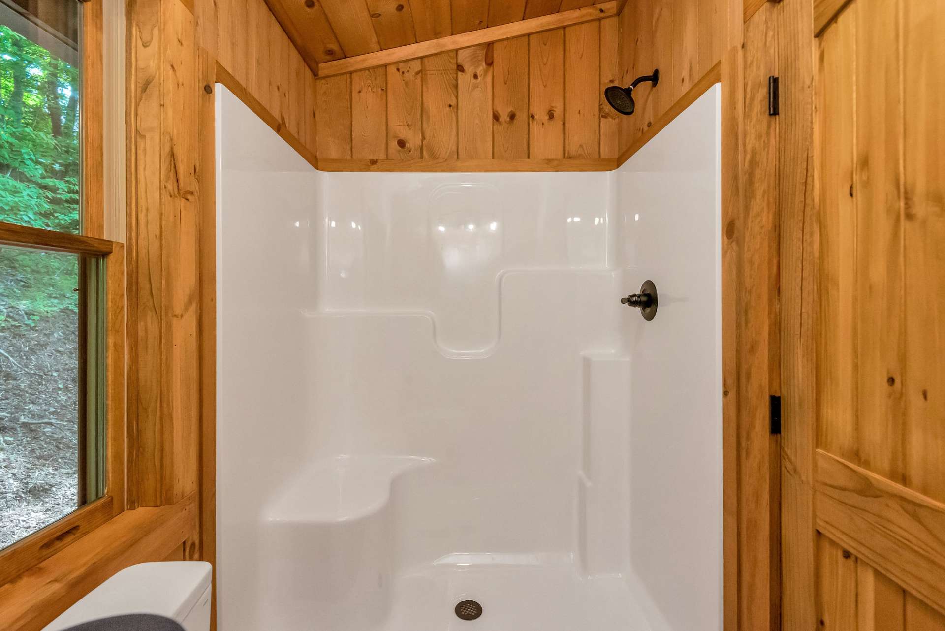 A fiberglass shower with a comfortable seat offers convenience and relaxation in the ensuite bathroom.