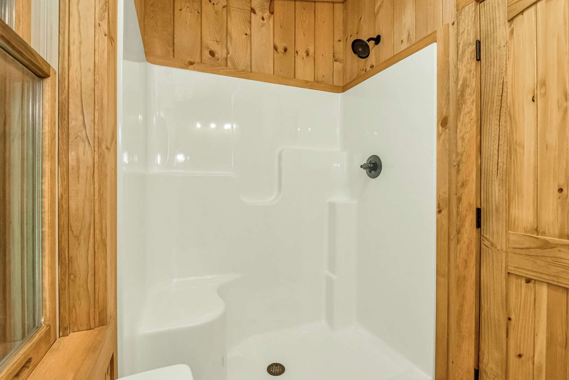 This bath includes a fiberglass tub/shower combination, providing a comfortable and functional space for bathing and showering.