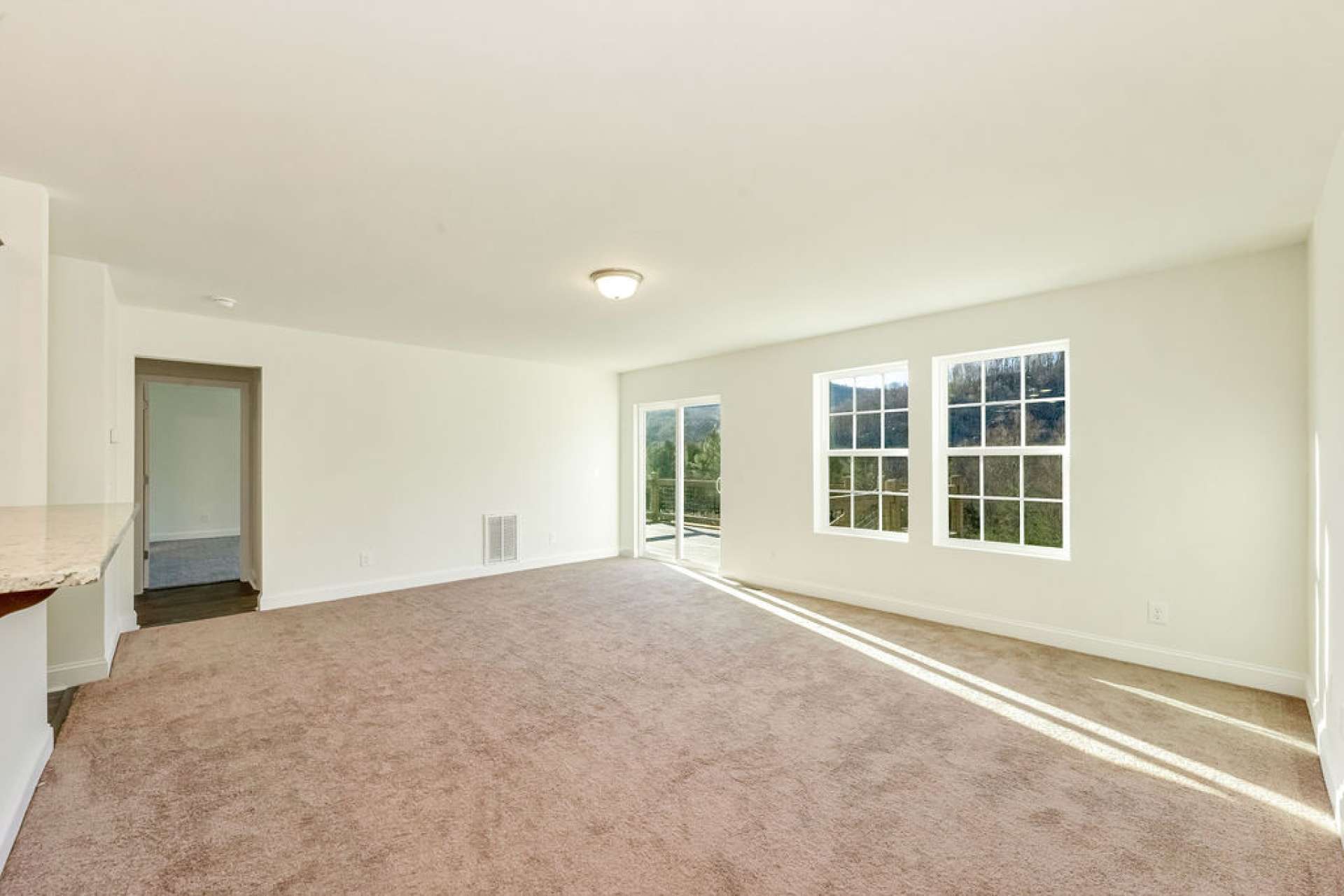 Living room door leads to half bath, mudroom off garage and primary