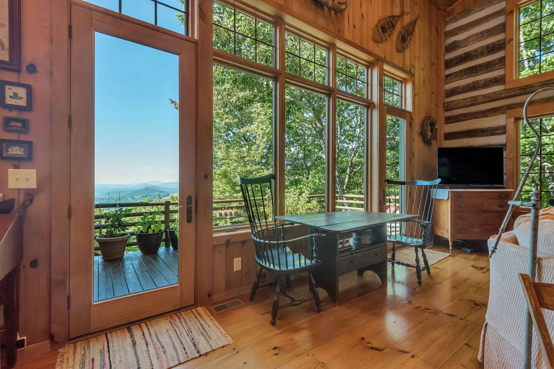 A wall of windows floods the space with natural light, showcasing stunning views and seamlessly blending the indoors with the beauty of the outdoors. The cabin has central A/C but Pella windows open out should you opt to enjoy a cool mountain breeze....