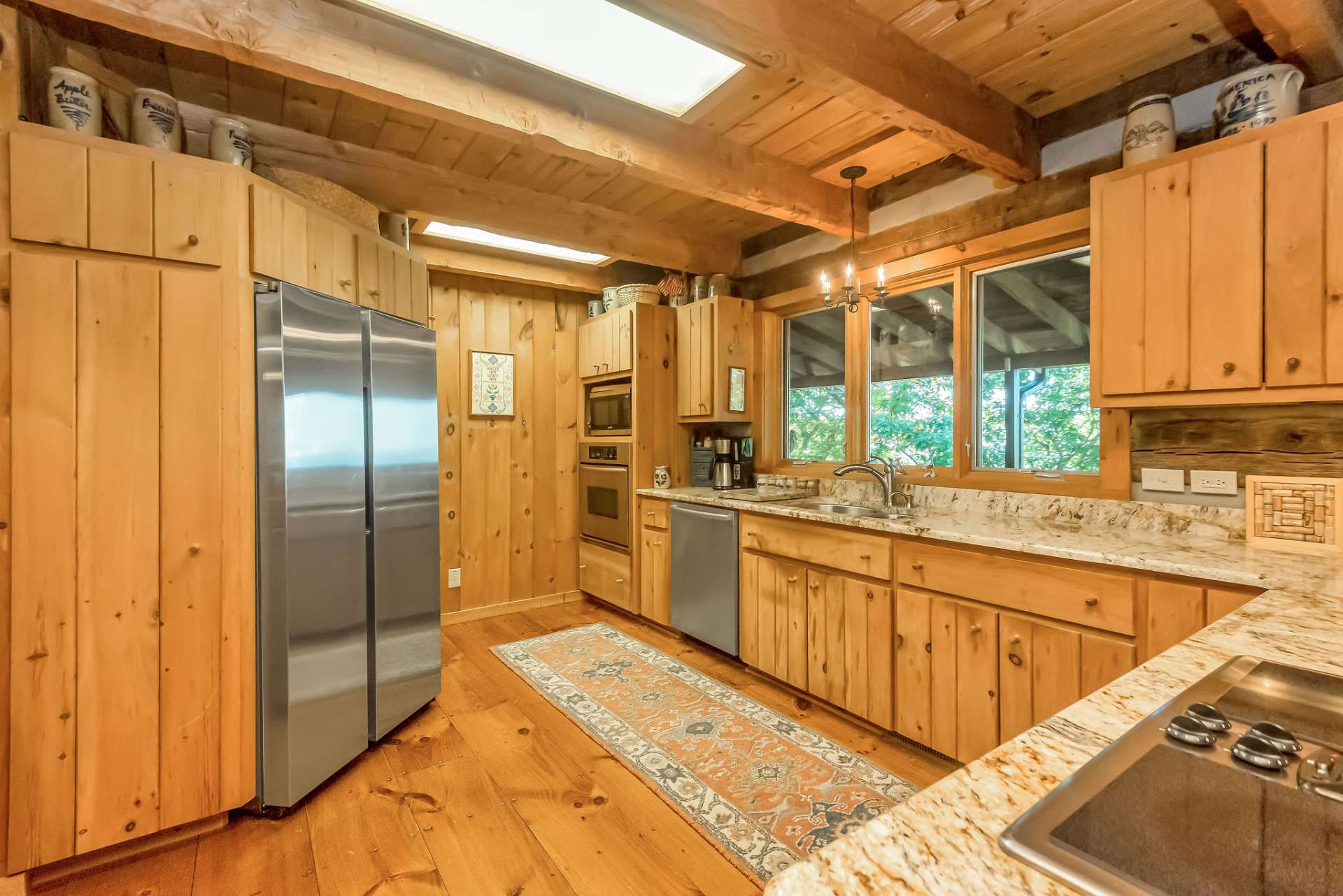 This kitchen offers ample storage with multiple pantries and cabinets featuring practical pull-out shelves.