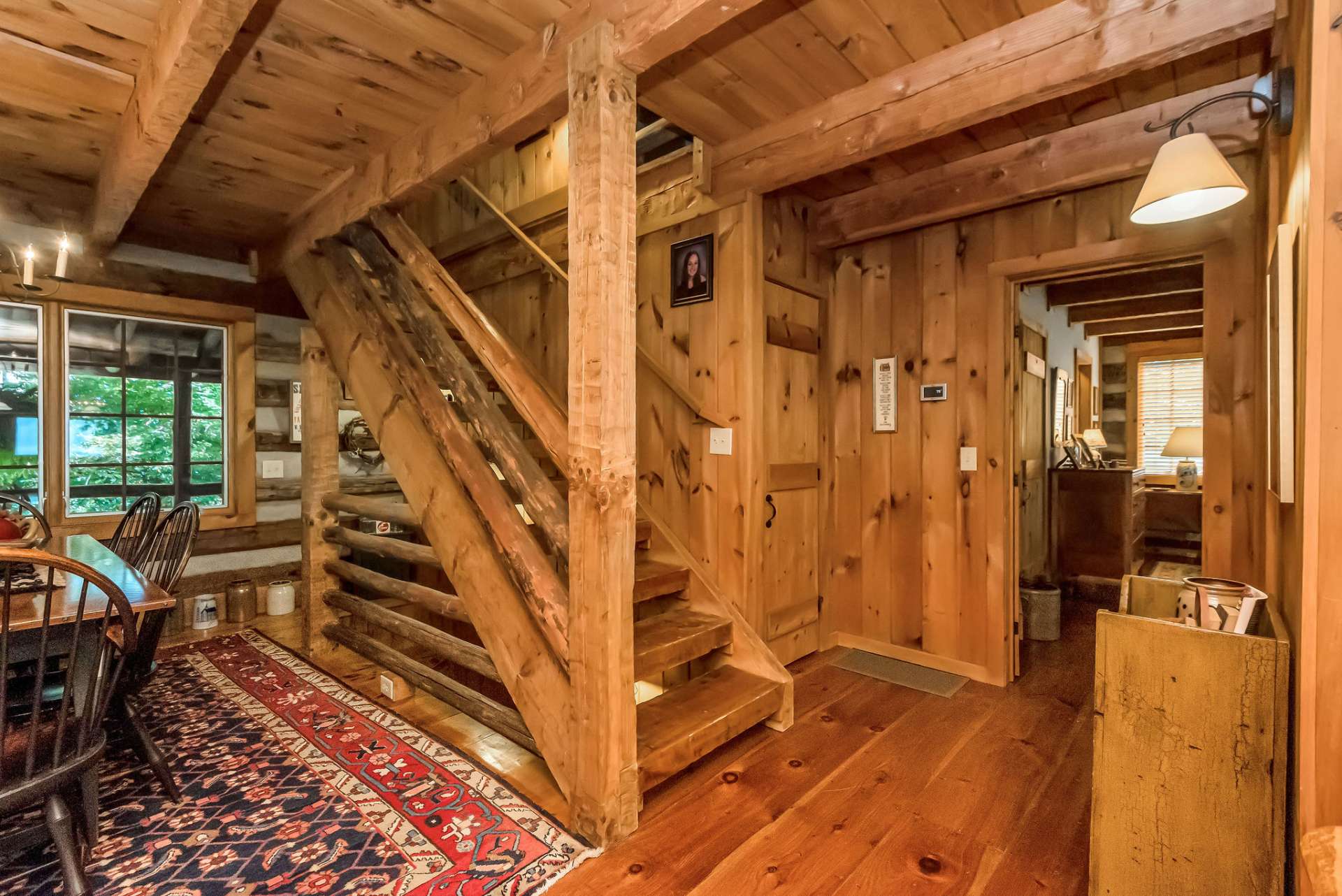 Hand-hewn stairs guide you to the loft and lower level. A coat closet just off the stairs comes in handy during winter months.