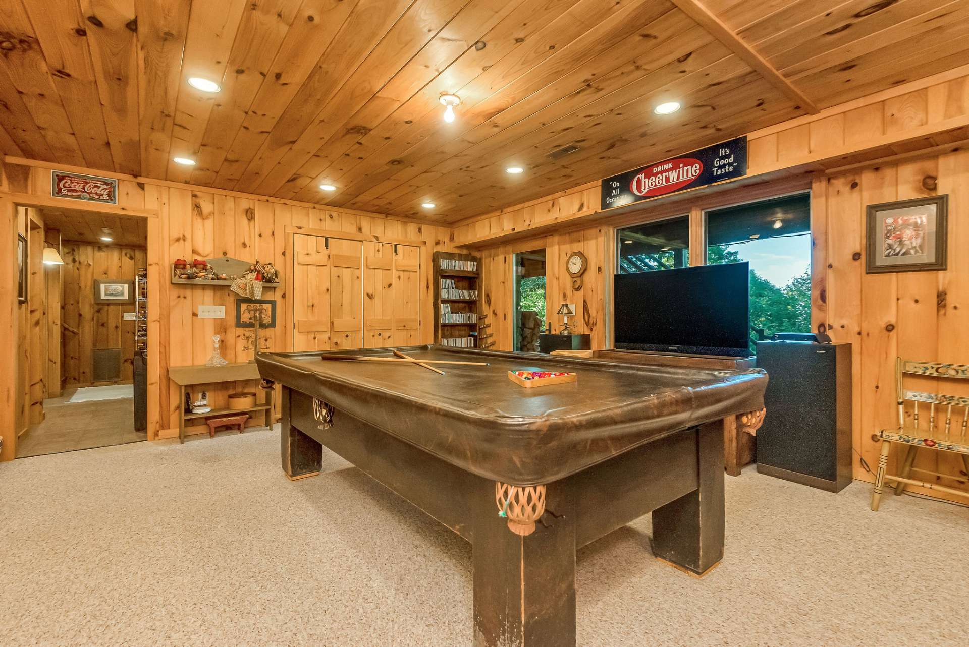 Invite your neighbors over to relax and enjoy the family and game room. The wall of cabinets and built-in shelving add storage to this well-designed home.