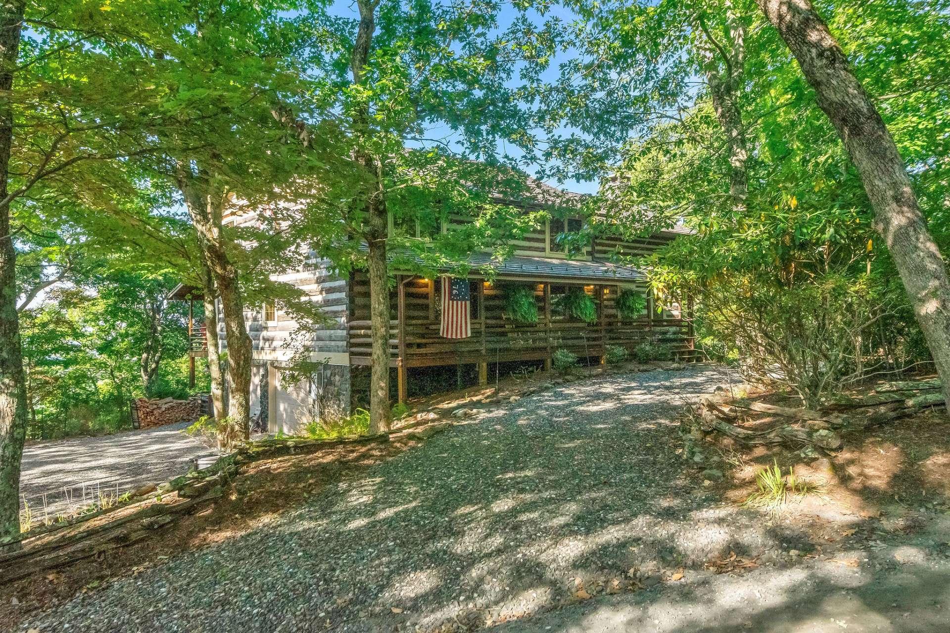 Ample parking with a circular drive and a lower driveway leading to the 2-car garage.