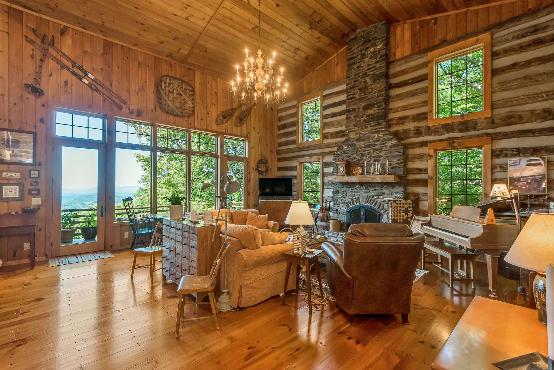 Step inside to the magnificent great room, with a wall of windows to showcase the layered views and a stunning native stone wood-burning fireplace that serves as the centerpiece of this grand space.