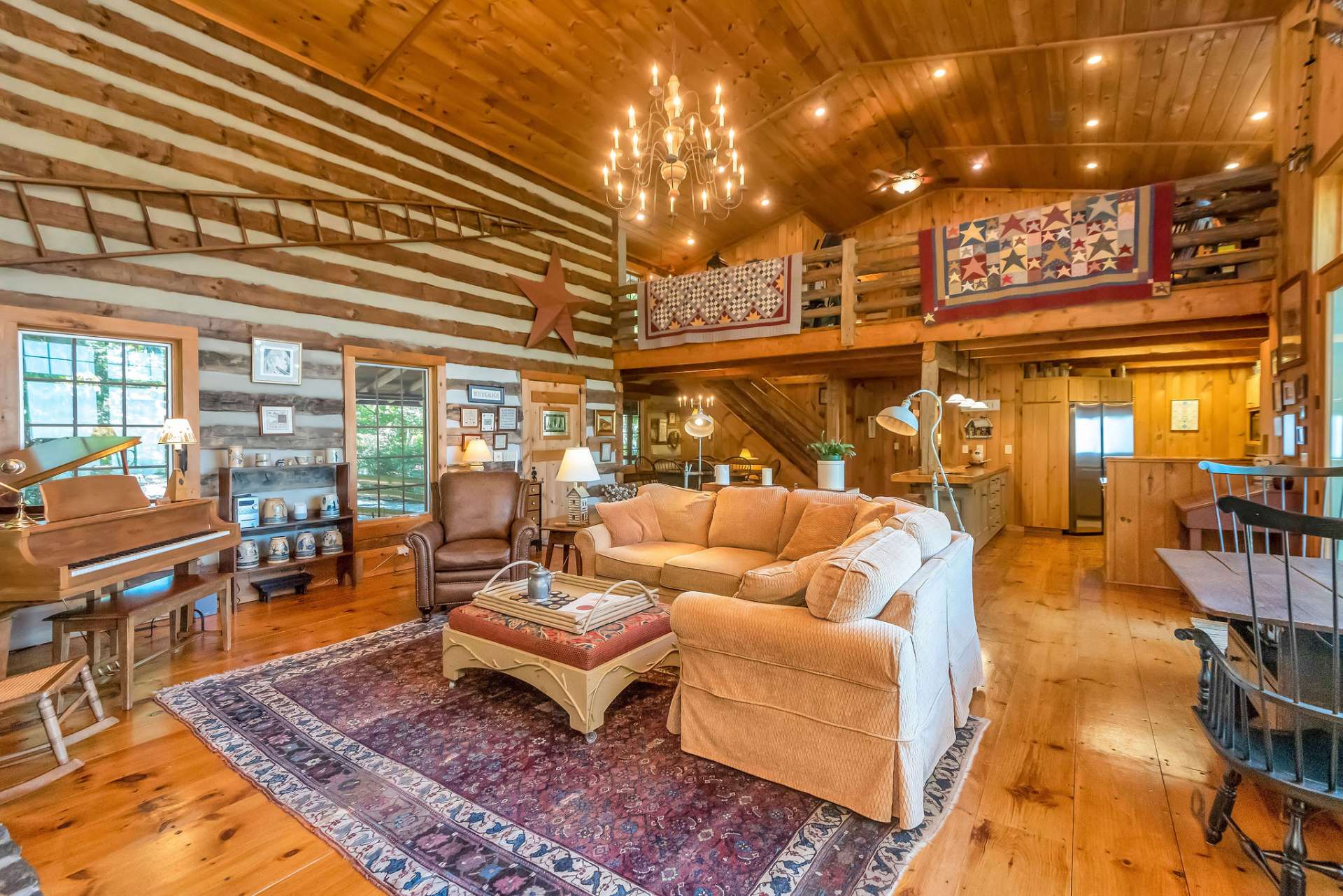 The vaulted ceilings and a view to the large open loft add to the expansive great room.