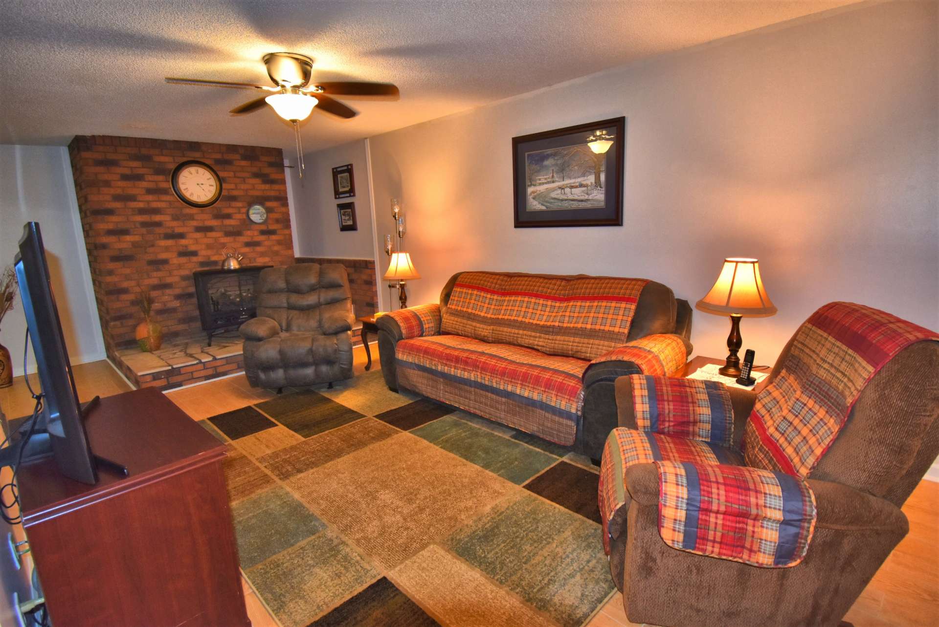 The lower level living area features new flooring and a gas log stove with the option of having a wood burning stove.