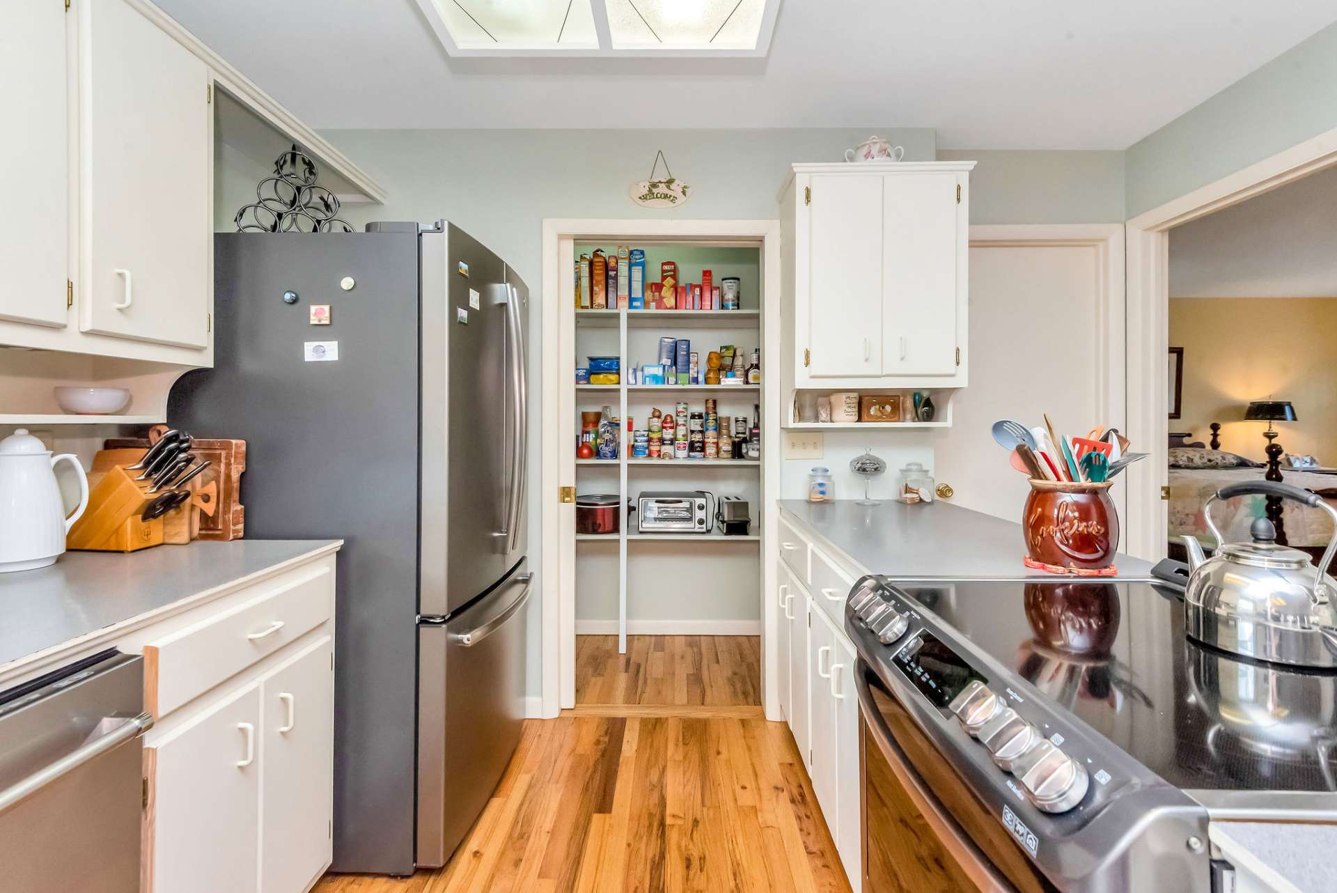 Notice the stainless appliances and the large pantry closet.