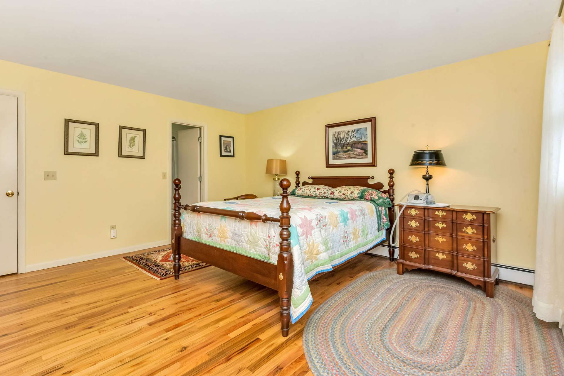 A spacious main level primary bedroom features double closets