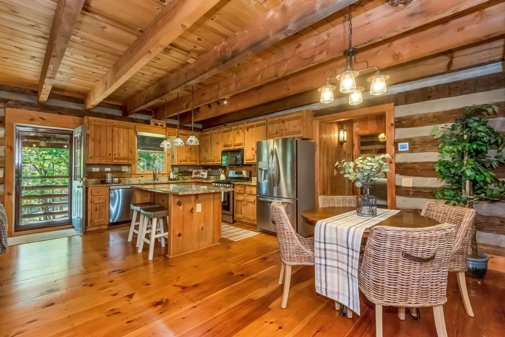 Delight in conversations with family and guests while preparing meals in this kitchen, featuring a gas range and sleek stainless steel appliances.