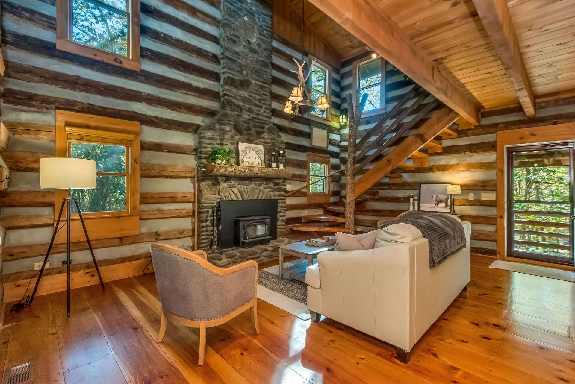 Step into the great room, where a natural stone fireplace creates a warm focal point, and the light, airy ambiance invites you to relax and unwind.