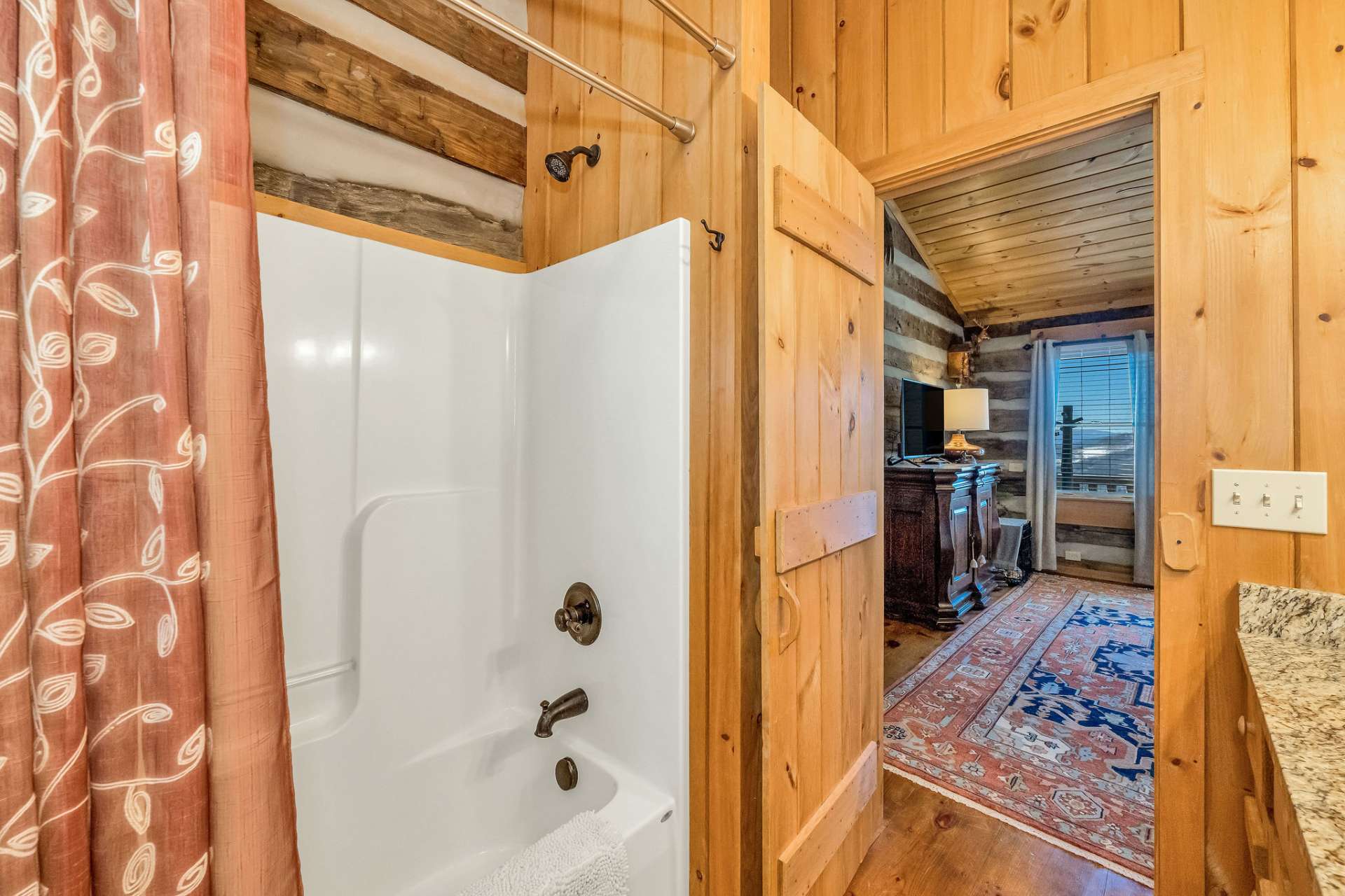 A handy linen closet is tucked behind the bathroom door.