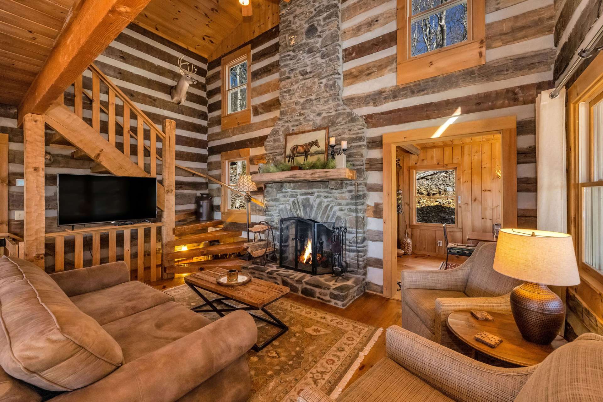 A dramatic floor-to-ceiling wood-burning fireplace serves as the heart of the home.