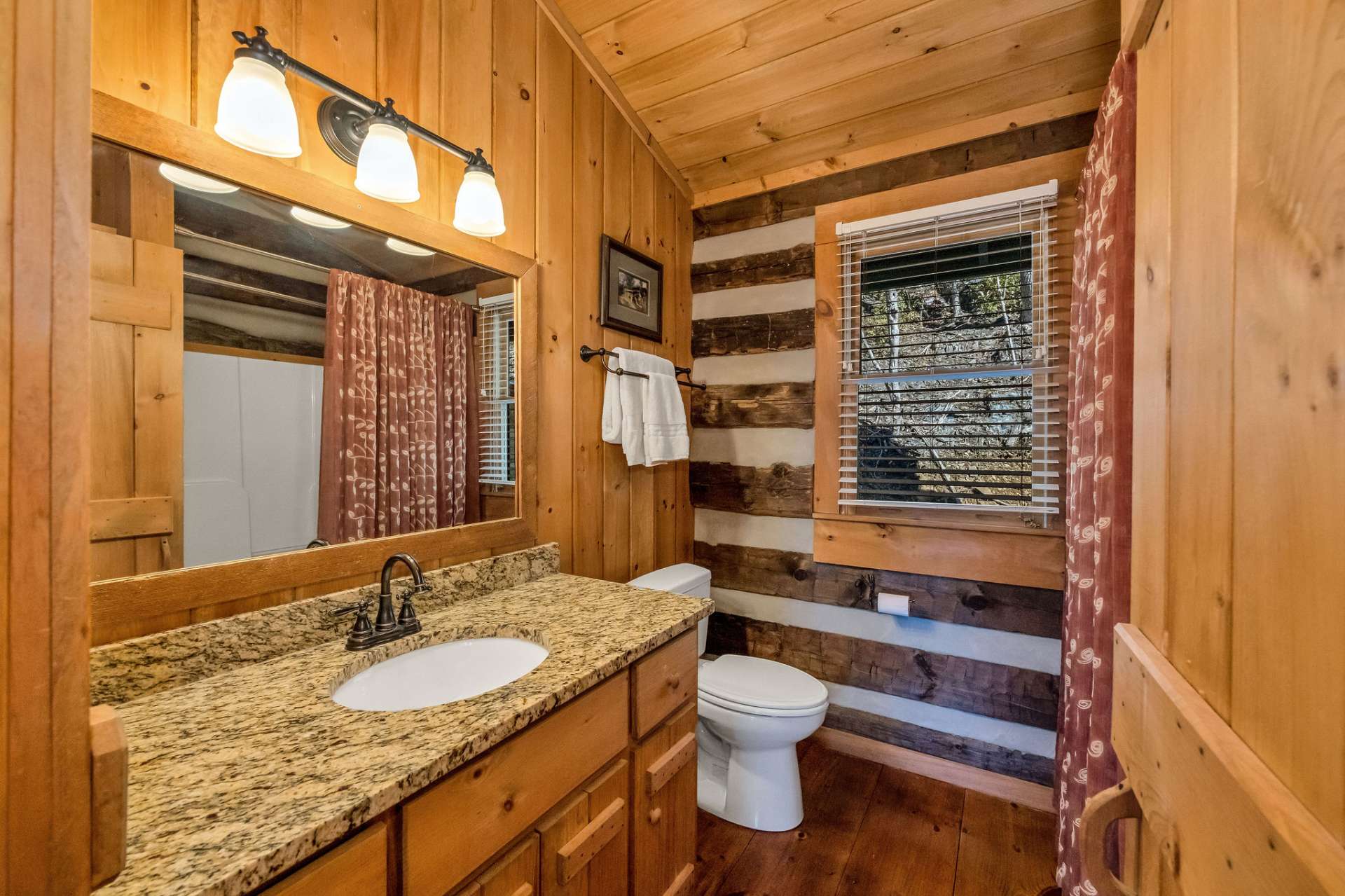 The main-level ensuite bath is complete with granite countertops and a tub shower combo.