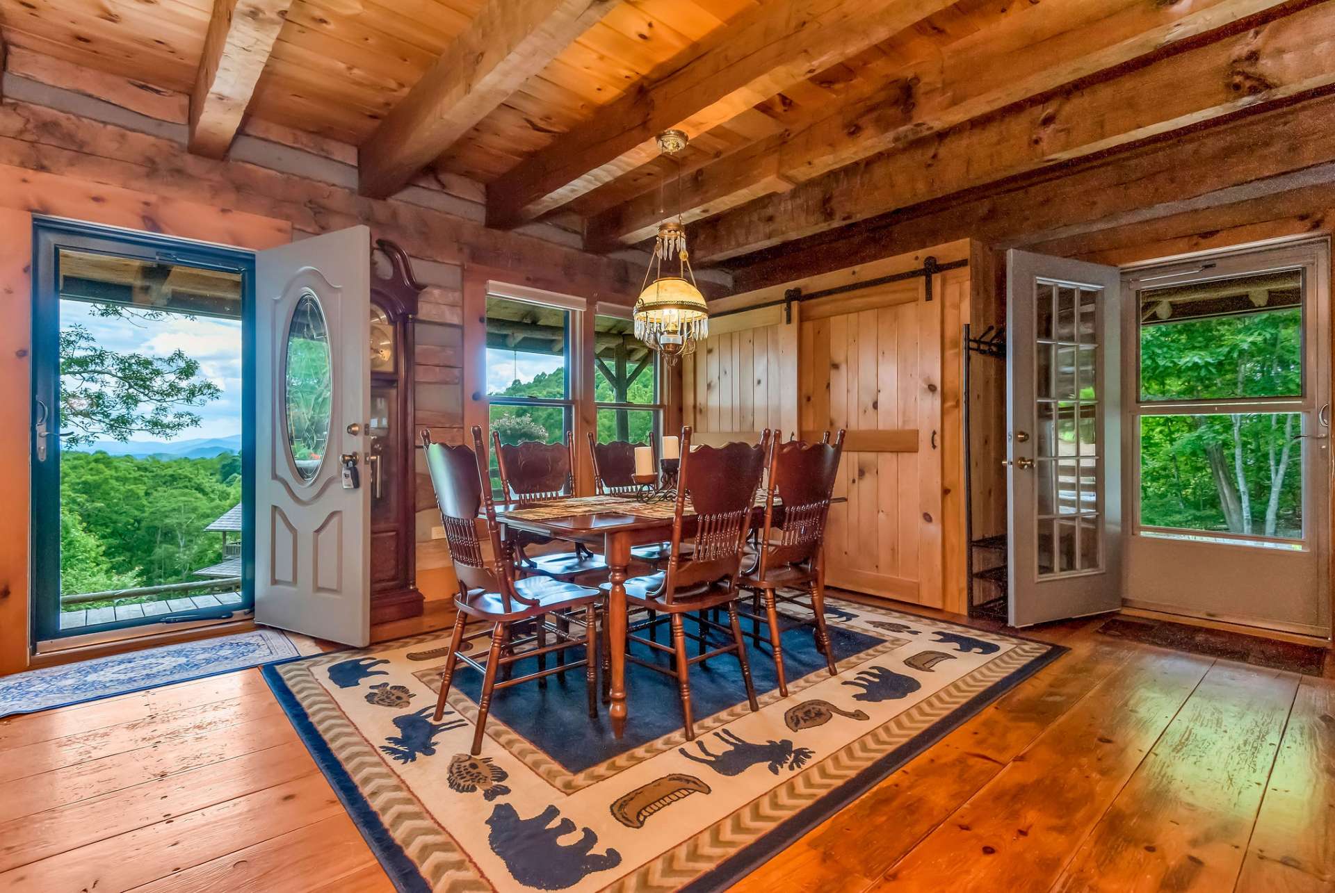 The dining area offers a hand-crafted pantry with sliding barn doors.