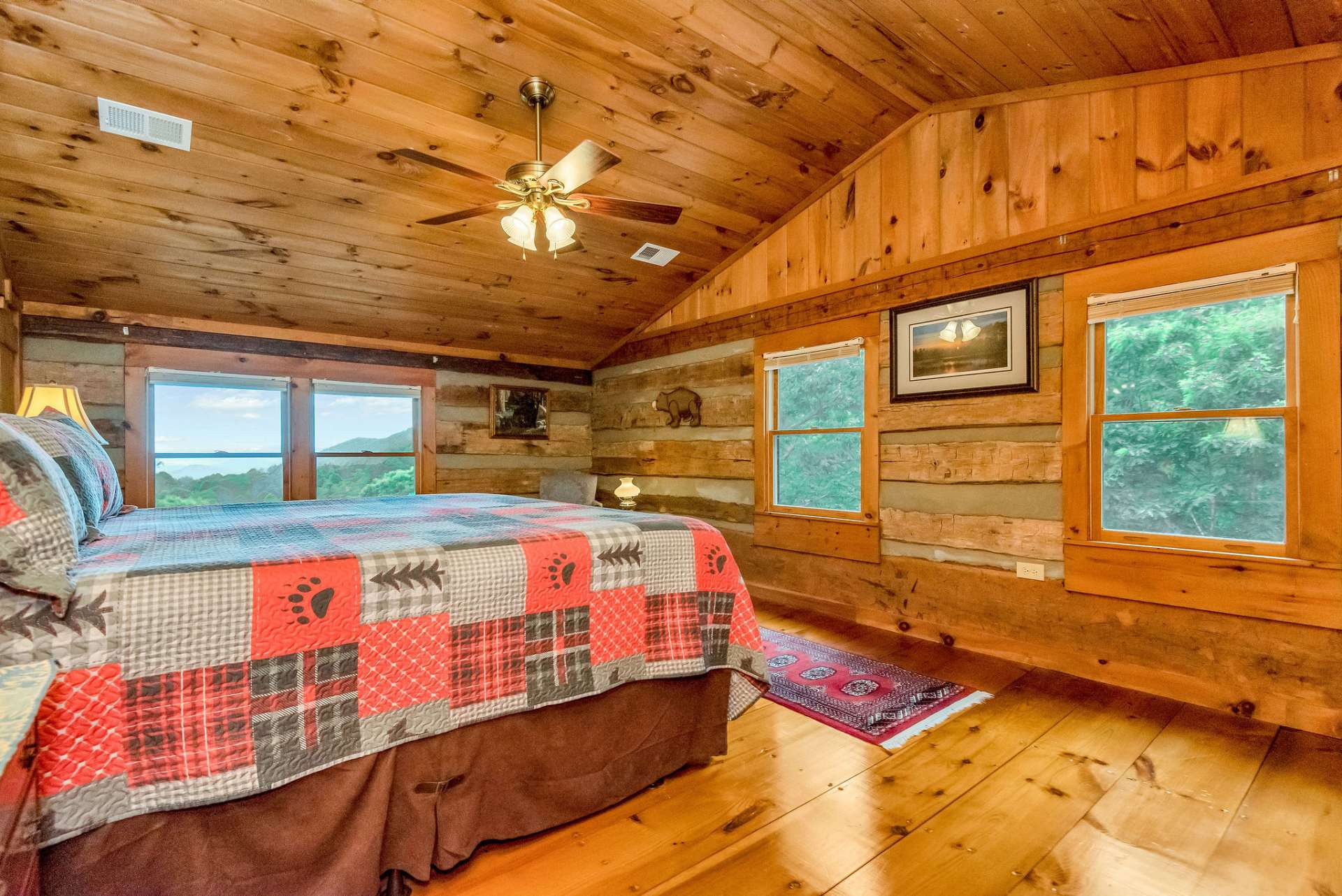 The additional guest room has two walls of windows creating picturesque backdrops.